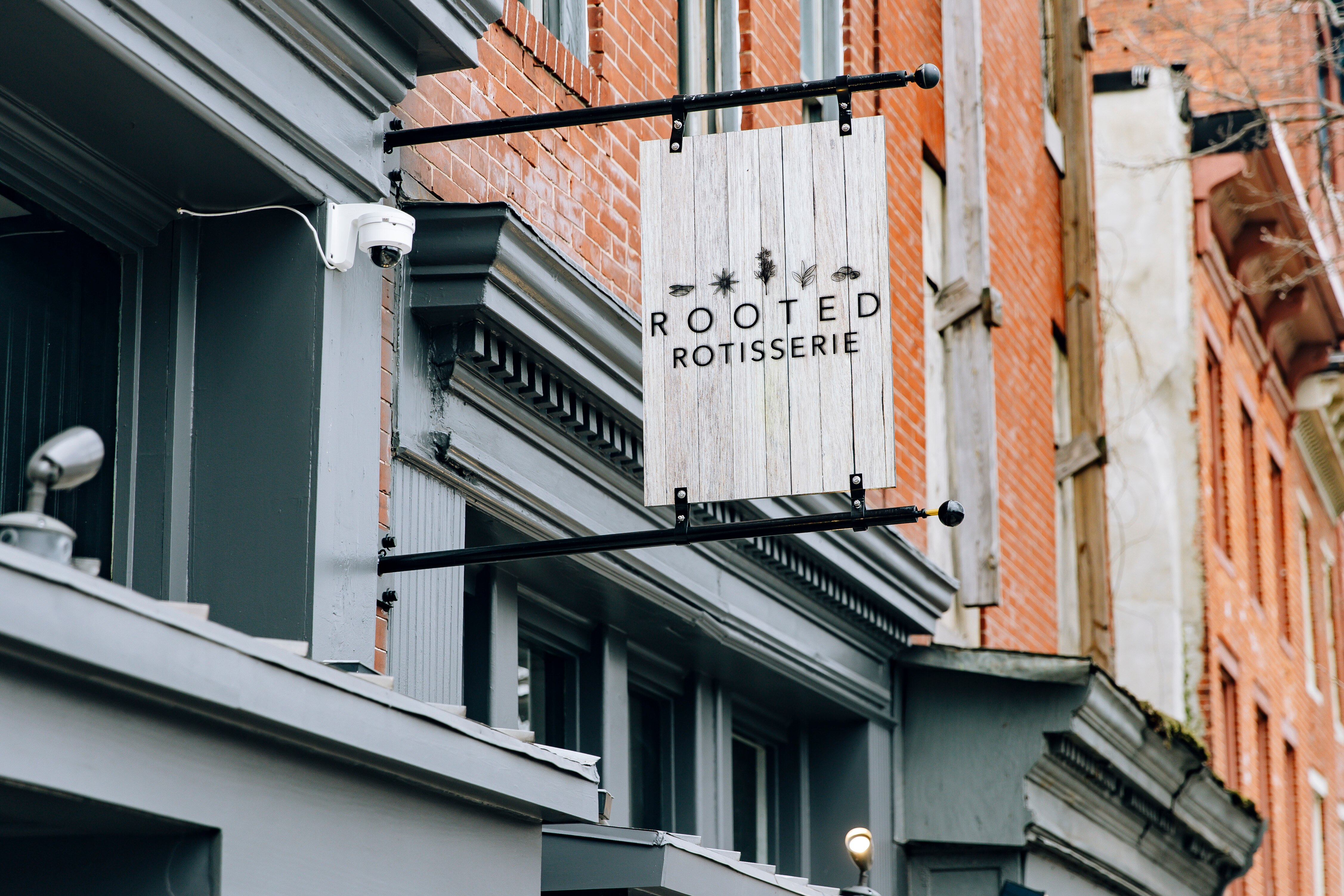 The sign for Rooted Rotisserie, as seen on Tuesday, Feb. 22, 2024, in Baltimore.