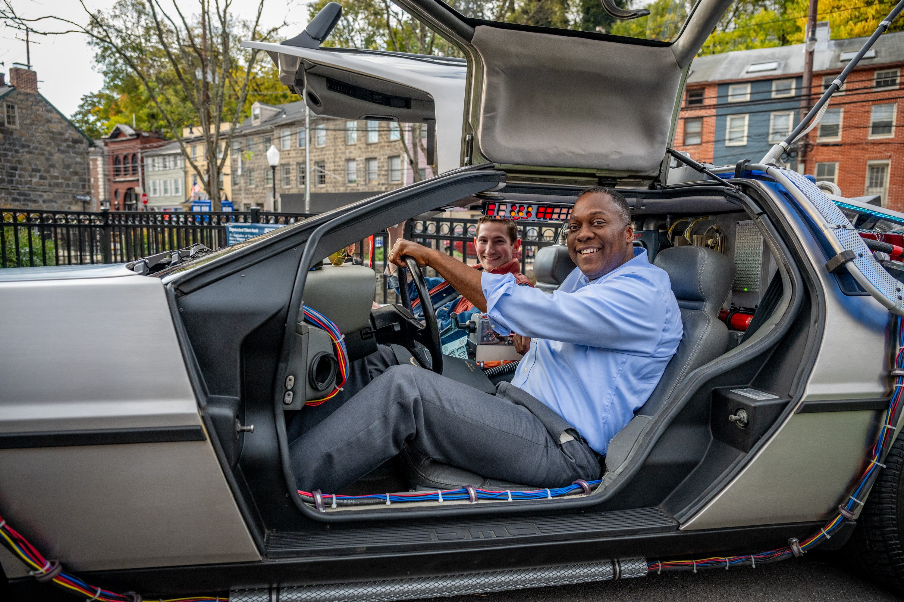 Howard County Executive Calvin Ball and his deputy chief of staff Felix Facchine, dressed as Marty McFly, sit in a DeLorean modeled after the car from “Back to the Future.”