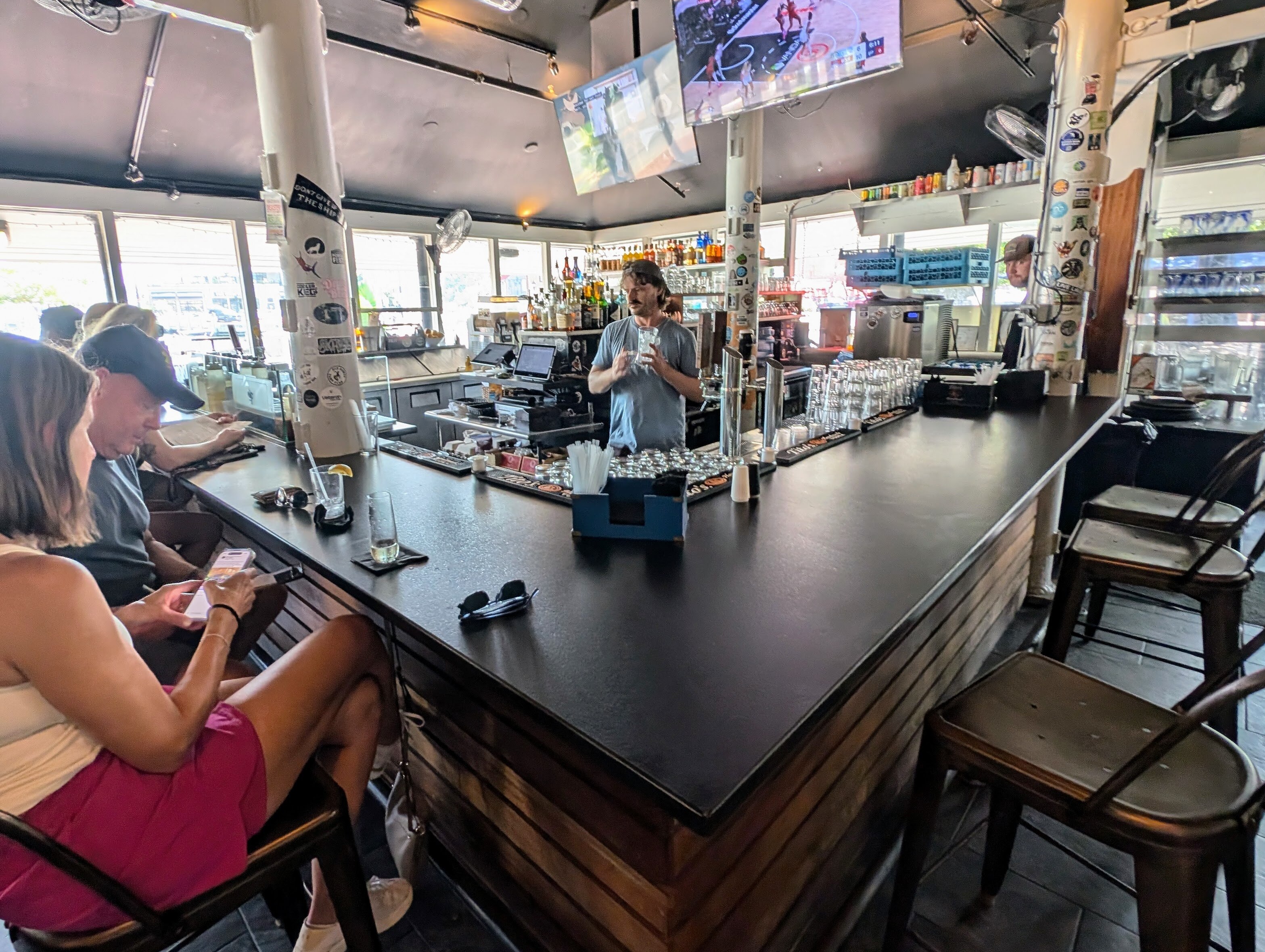 Willie Hughes serves up drinks to a bar full of late lunchers at the Market House. He's been working there for a year after moving to Annapolis from Iowa.