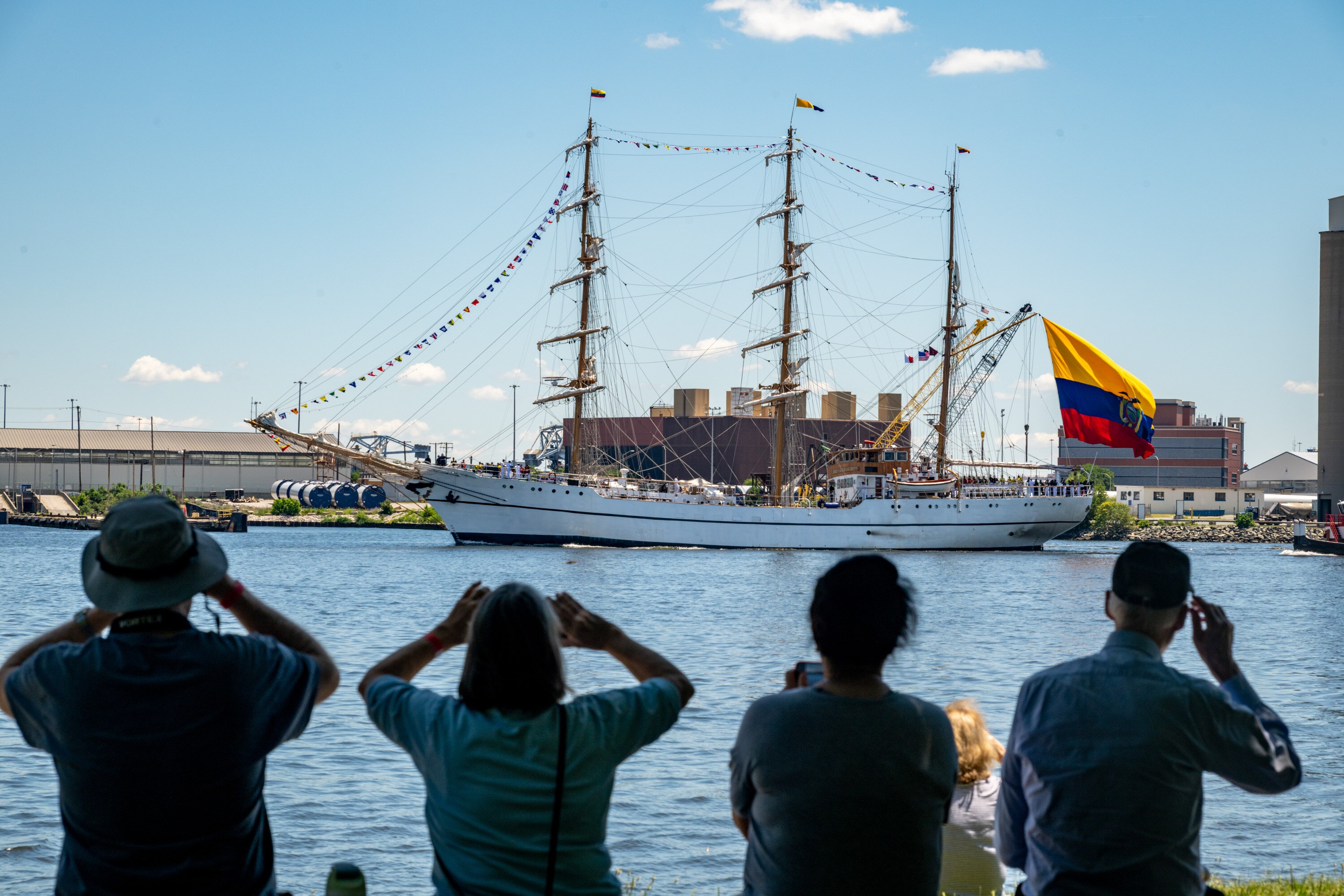 Ship watchers at Fort McHenry take photos of Ecuador’s sail training vessel the BAE Guayas as it enters Baltimore’s harbor for Sail250. 