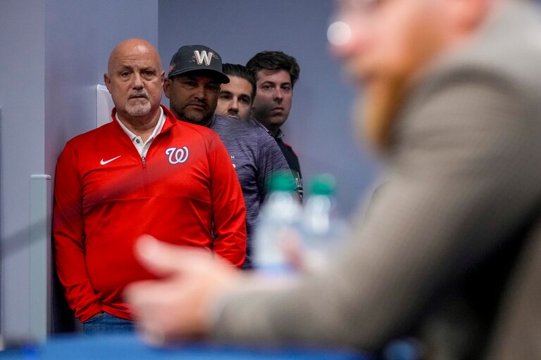 Washington Nationals general manager Mike Rizzo, left, and Washington Nationals manager Dave Martinez, second from left, watch as Washington Nationals relief pitcher Sean Doolittle, foreground, speaks at a news conference after announcing his retirement at Nationals Park, Friday, Sept. 22, 2023, in Washington. Doolittle has decided to retire from baseball after more than a decade pitching in the majors that included helping the Nationals win the World Series in 2019.