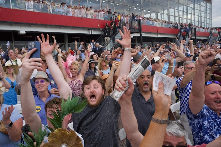 People celebrate from the apron as Journalism, ridden by Umberto Rispoli, wins the Preakness Stakes on Saturday, May 17, 2025.