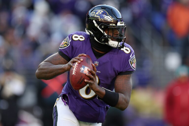 BALTIMORE, MARYLAND - NOVEMBER 20: Lamar Jackson of the Baltimore Ravens rolls out of the pocket in the fourth quarter of a game against the Carolina Panthers at M&T Bank Stadium on November 20, 2022 in Baltimore, Maryland.