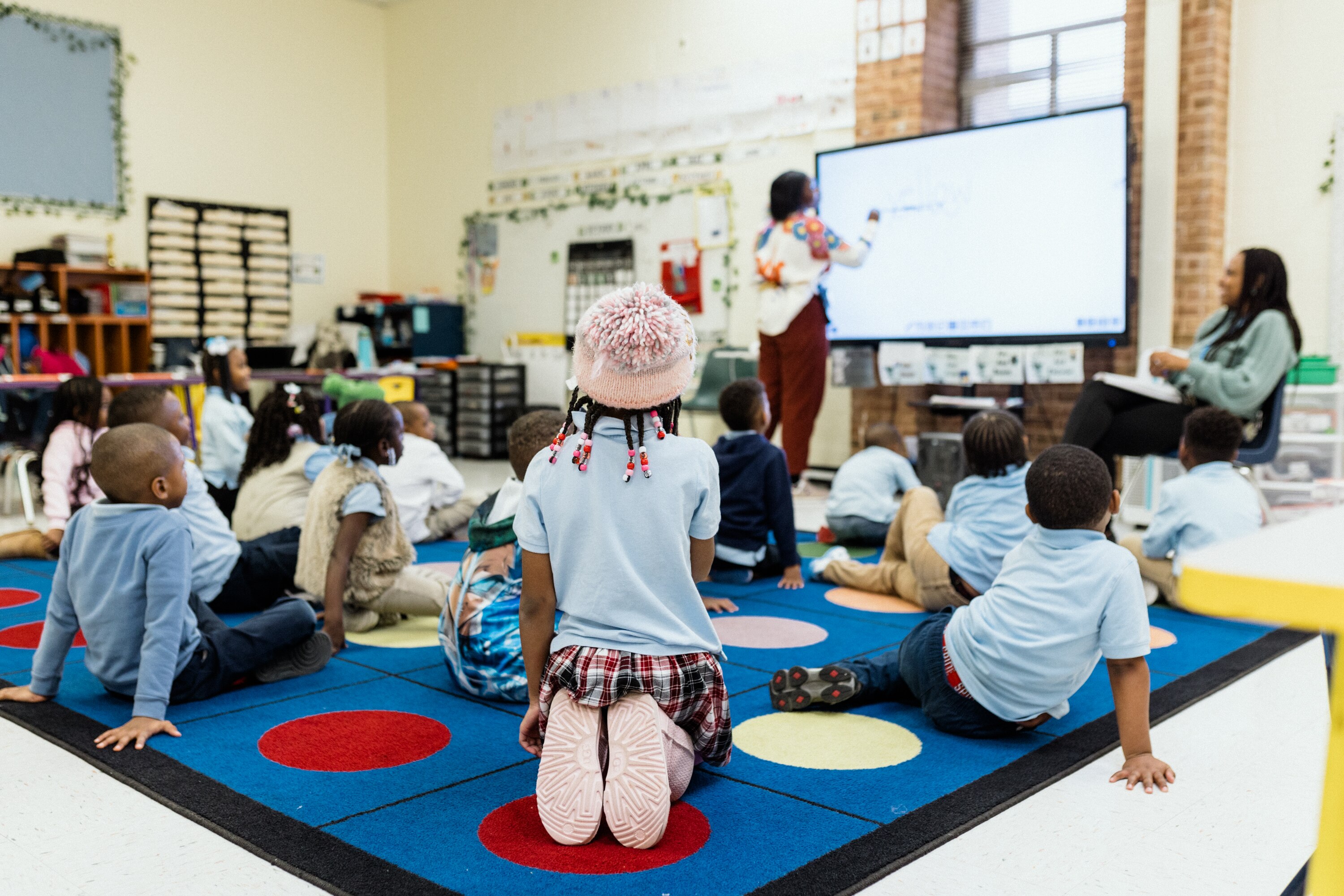 BALTIMORE, MD - DECEMBER 5, 2024: Kindergarten students pay attention to their teacher during an English Language Arts class in KIPP Baltimore on December 5, 2024.