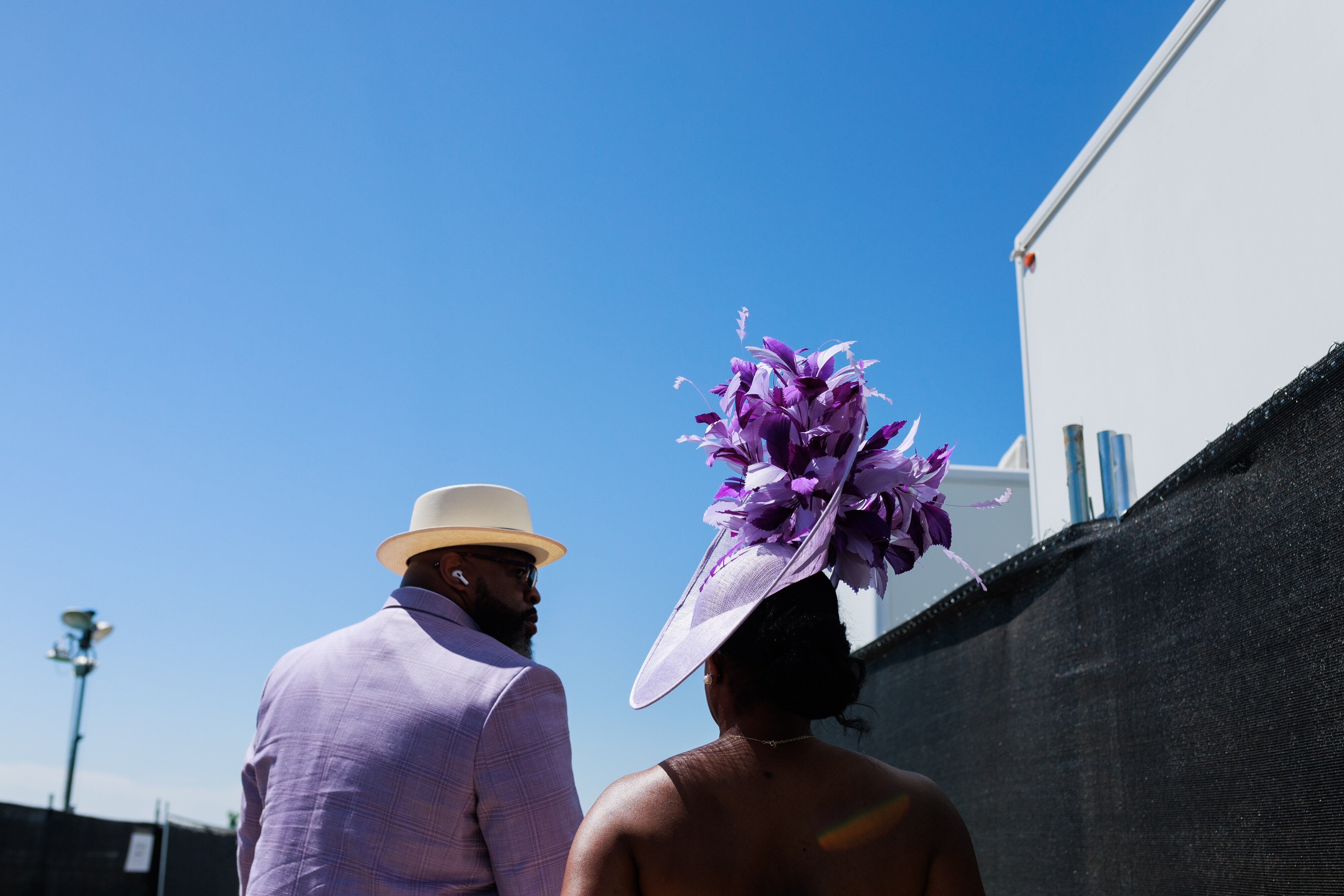 A couple head to the infield during The Preakness Stakes at Pimlico Race Course on Saturday, May 17, 2025, in Baltimore.