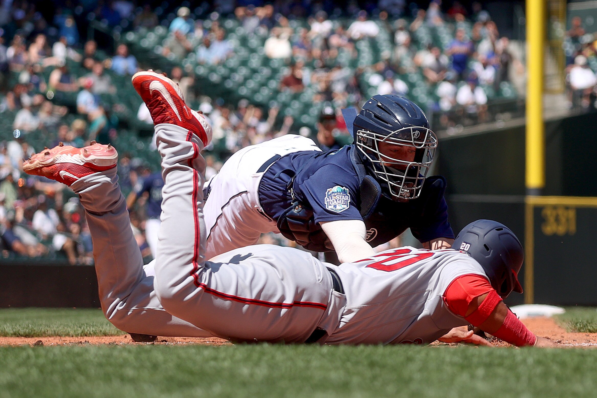 Keibert Ruiz of the Nationals is called out at home plate as Tom Murphy of the Mariners reaches to make the tag during the sixth inning Wednesday in Seattle. Ruiz was ruled out for leaving the baseline, and Nationals manager Dave Martinez was ejected for arguing the call.
