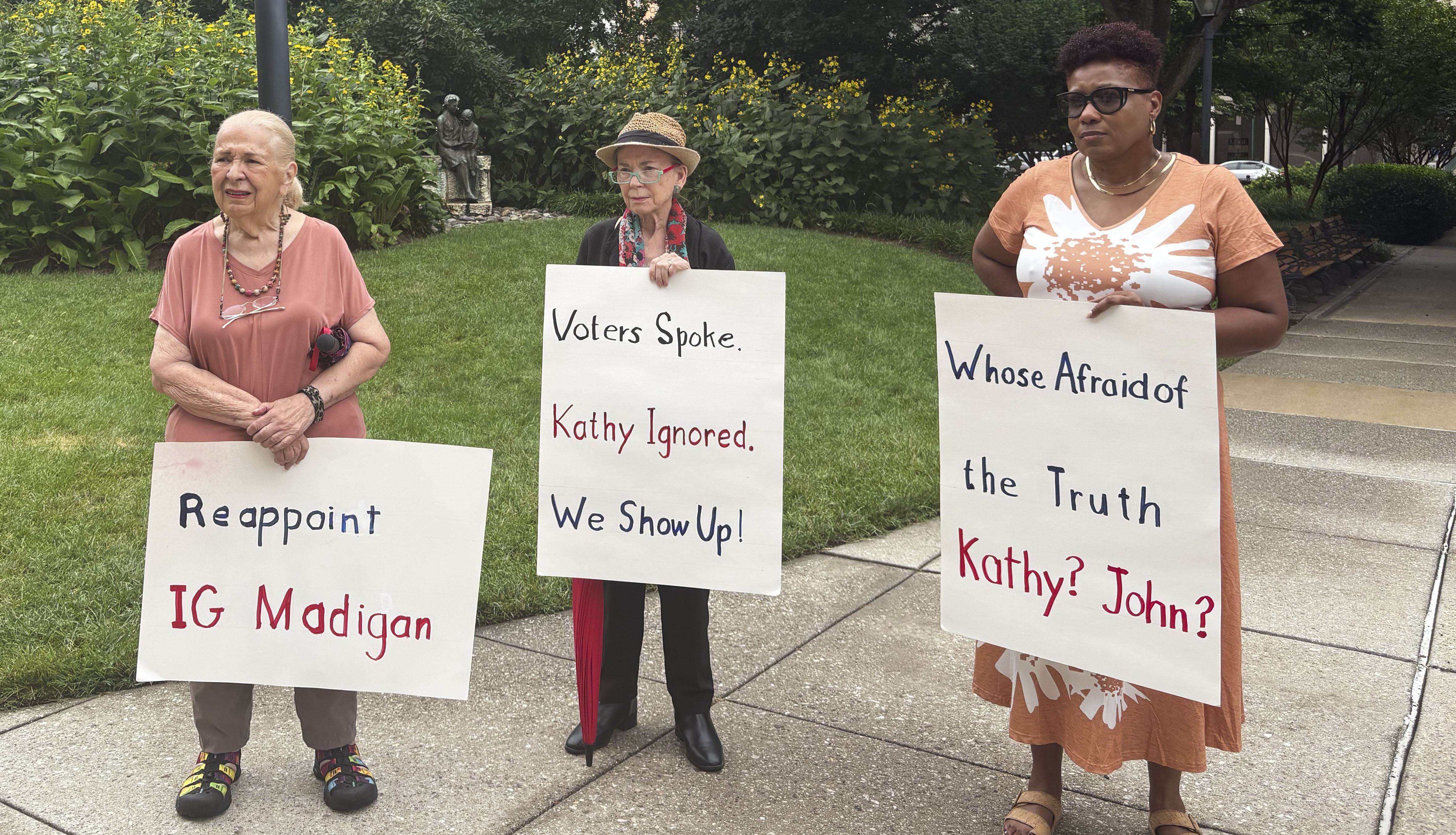 On Monday, Anne George, Peta Richkus and Marsha Briley-Savage protest County Executive Kathy Klausmeier’s decision not to reappoint Inspector General Kelly Madigan.
