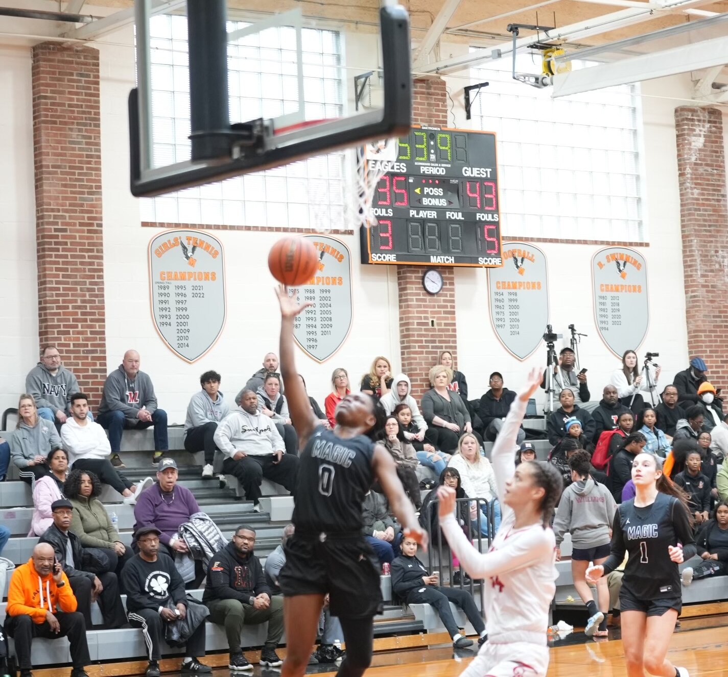 Mercy's Milan Brown goes in for a layup as Glen Burnie's Layla Washington watches during Saturday's girls basketball contest at the Public vs. Private Challenge. Brown finished with 14 points as the No. 9 Magic handed sixth-ranked Glen Burnie its first loss, 61-55, at McDonogh.