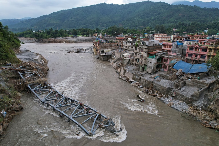 A drone view of a bridge damaged by flash flooding along the Tadi River in the Devighat area of Nuwakot district, Nepal, Saturday, Aug. 29, 2026. (AP Photo/Rajesh Kumar Singh)