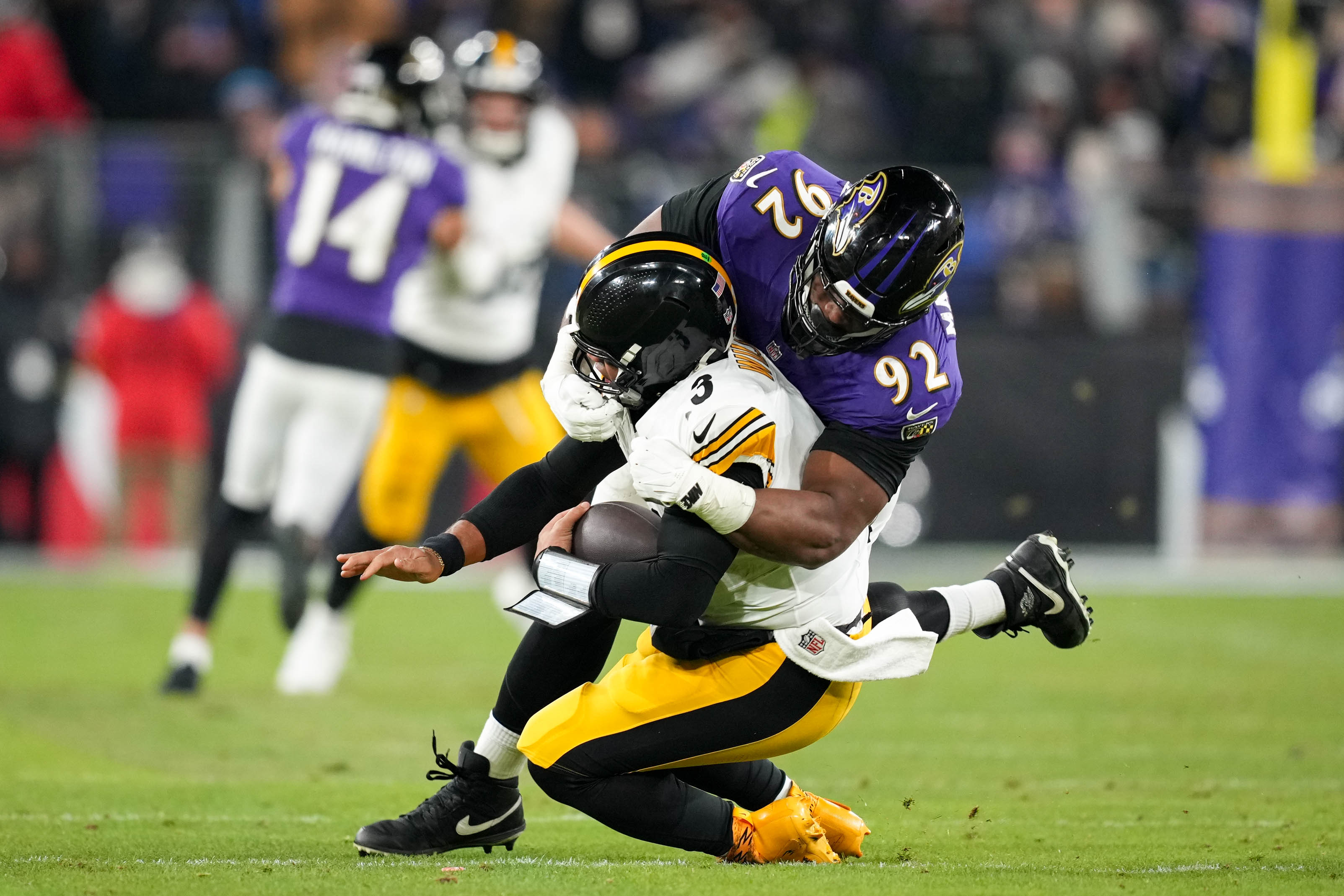 Baltimore Ravens defensive tackle Nnamdi Madubuike (92) sacks Pittsburgh Steelers quarterback Russell Wilson (3) in the AFC wild card playoff game at M&T Bank Stadium on Saturday, January 11, 2025.