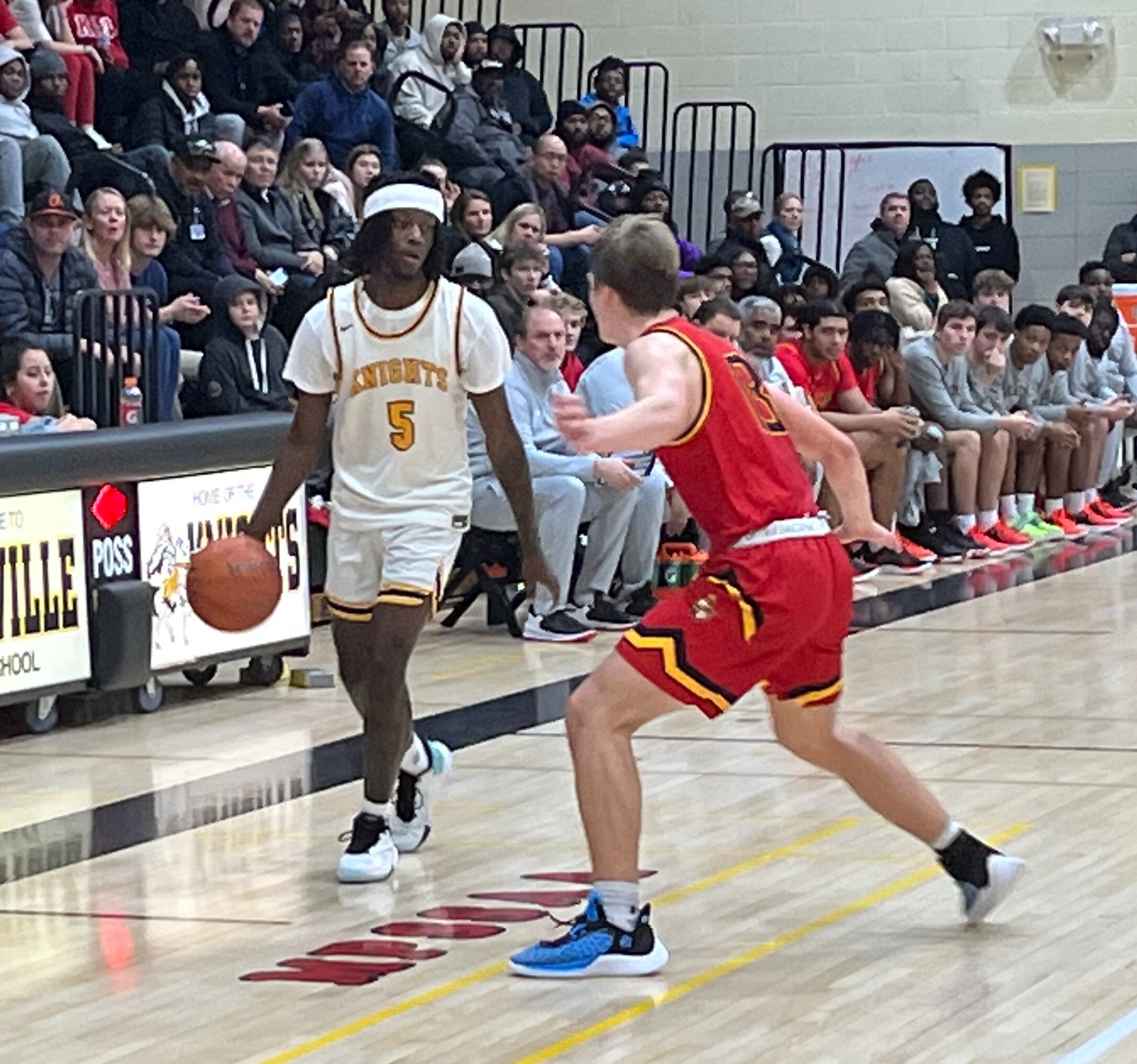 Parkville's Caron Smith is defended by Dulaney's Peter Hylind during Friday's Baltimore County boys basketball game. Smith finished with 37 points as the Knights remained undefeated with a 87-73 victory in Baltimore County.