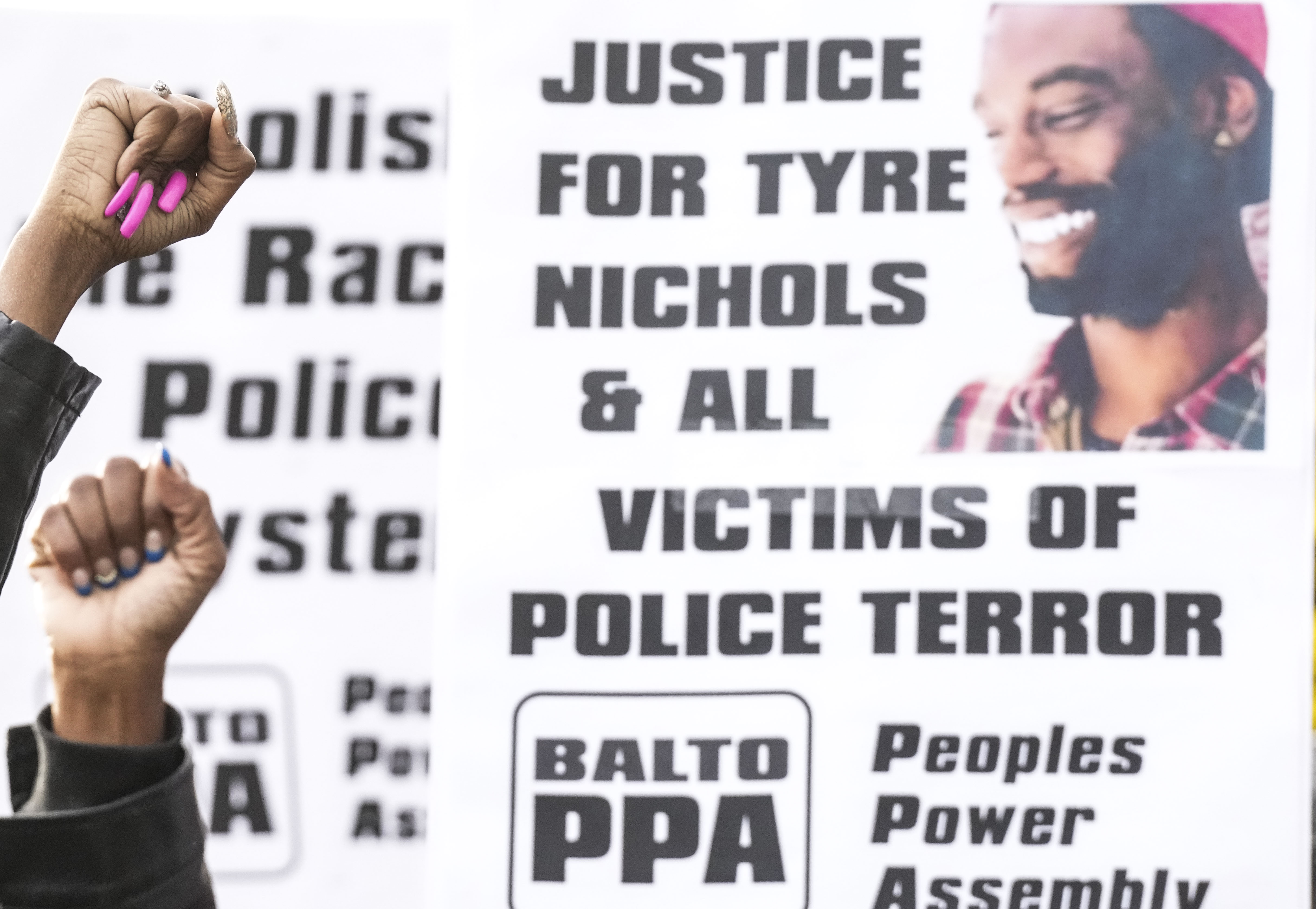 People gather to speak out on police brutality at a rally for Tyre Nichols on the corner of North Avenue and North Charles Street on January 28, 2023.