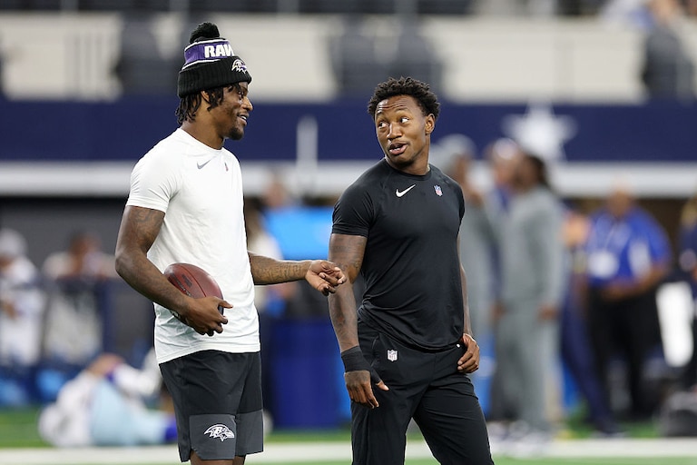 Lamar Jackson, left, and Zay Flowers participate in warmups prior to the Ravens' preseason game against the Dallas Cowboys on Aug. 16, 2025.