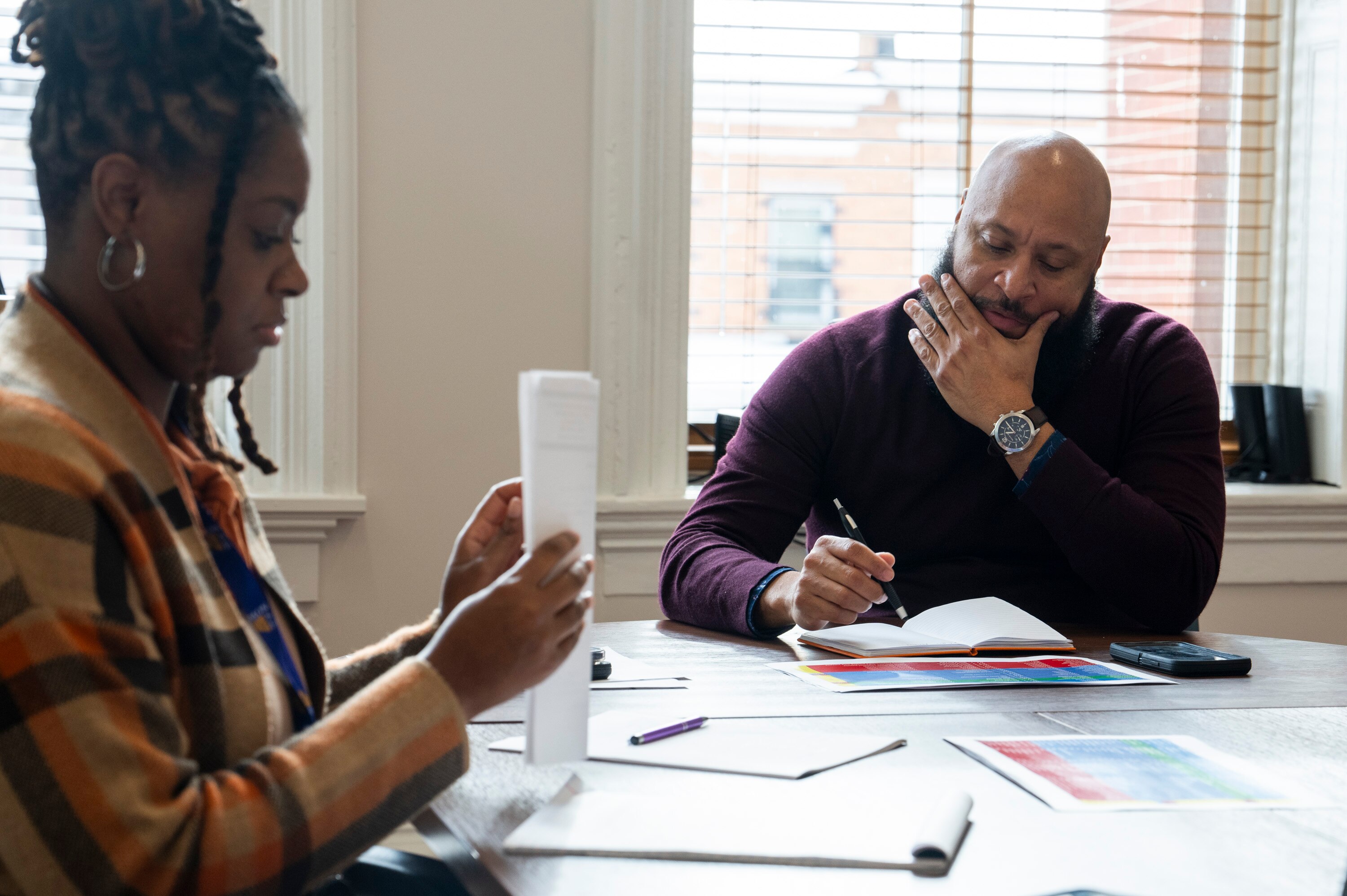 Tierra Morales, Social Services Coordination Supervisor, and Mark Mason, Associate Director of Victim Services, go down a checklist of people on January 24, 2024.