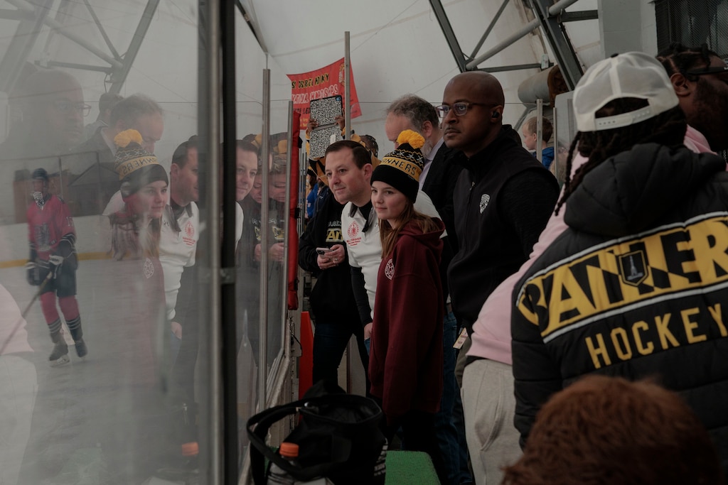 State Senator Bill Ferguson, center, watches the Baltimore Banners ice hockey team warm up.