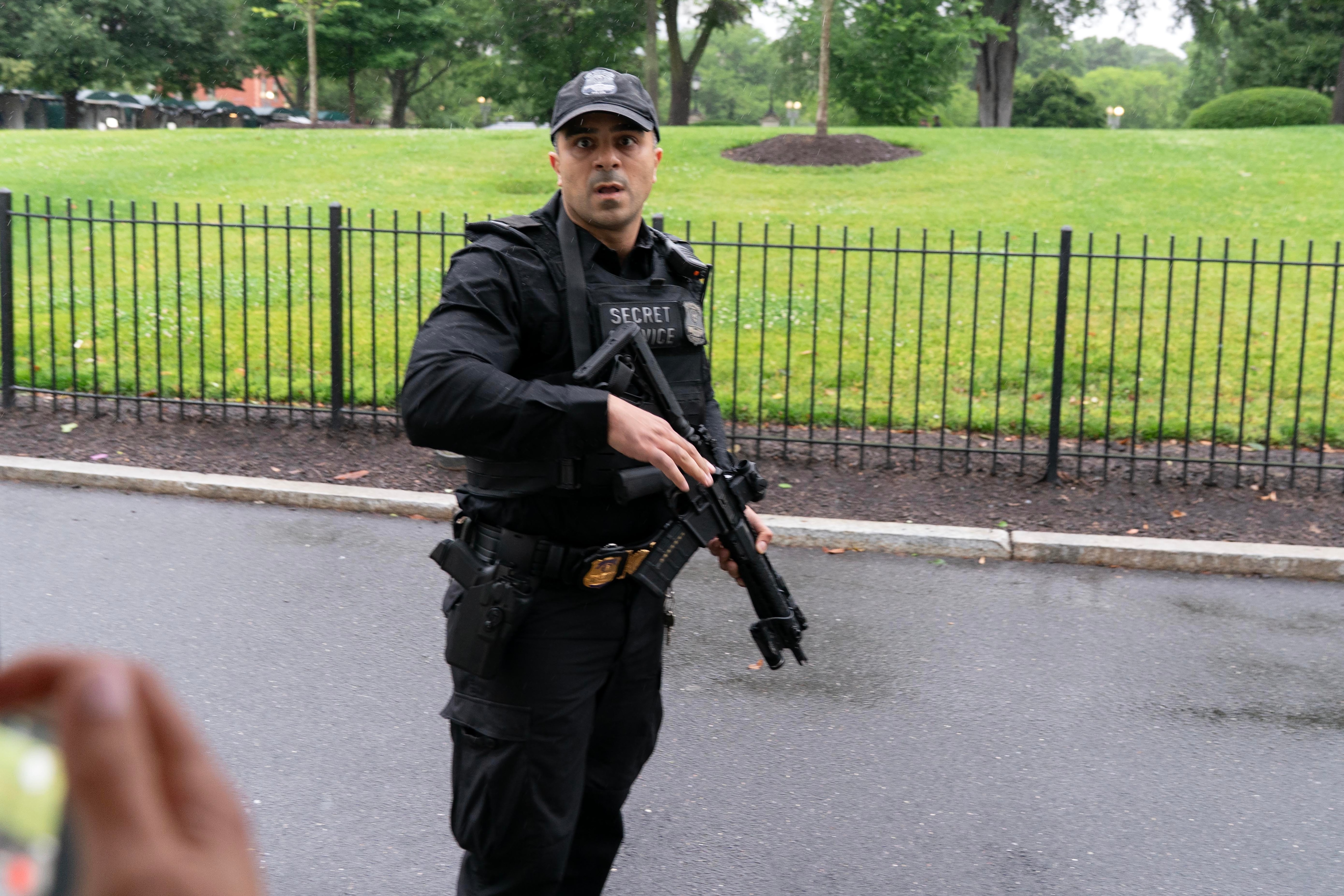 A member of the Secret Service stops journalist from leaving the White House, Saturday, May 23, 2026, in Washington. (AP Photo/Jose Luis Magana)
