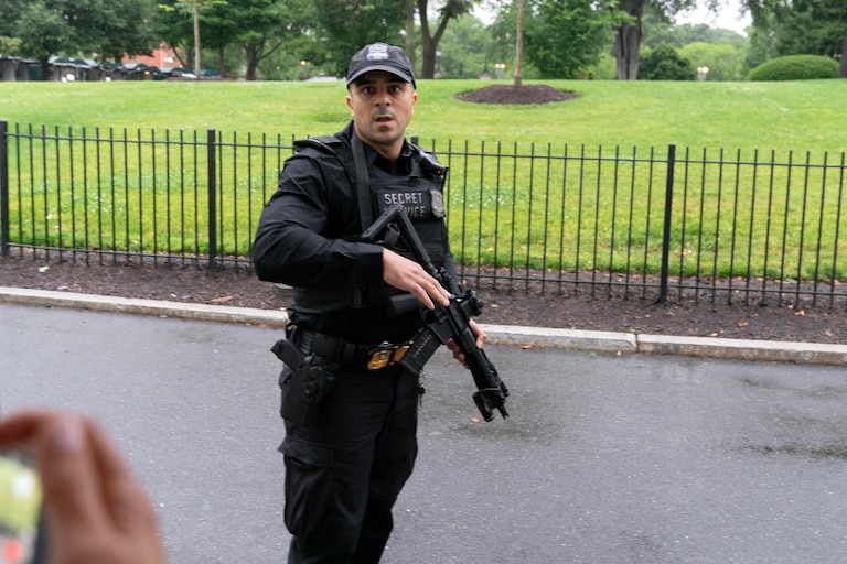 A member of the Secret Service stops journalist from leaving the White House, Saturday, May 23, 2026, in Washington. (AP Photo/Jose Luis Magana)