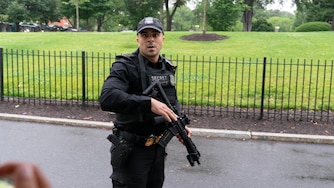 A member of the Secret Service stops journalist from leaving the White House, Saturday, May 23, 2026, in Washington. (AP Photo/Jose Luis Magana)