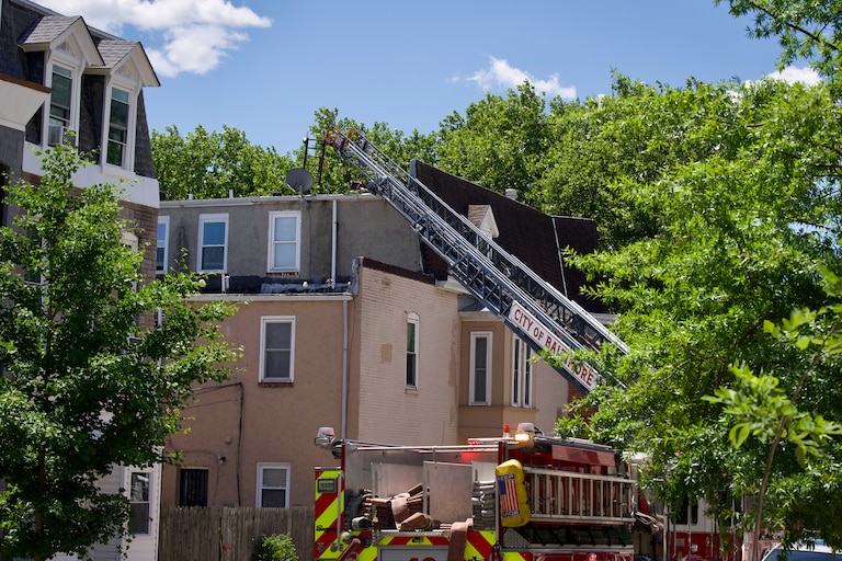 Baltimore City Fire responds to a three-alarm fire that erupted through upper levels of rowhomes in the Barclay neighborhood of Baltimore on Thursday afternoon.
