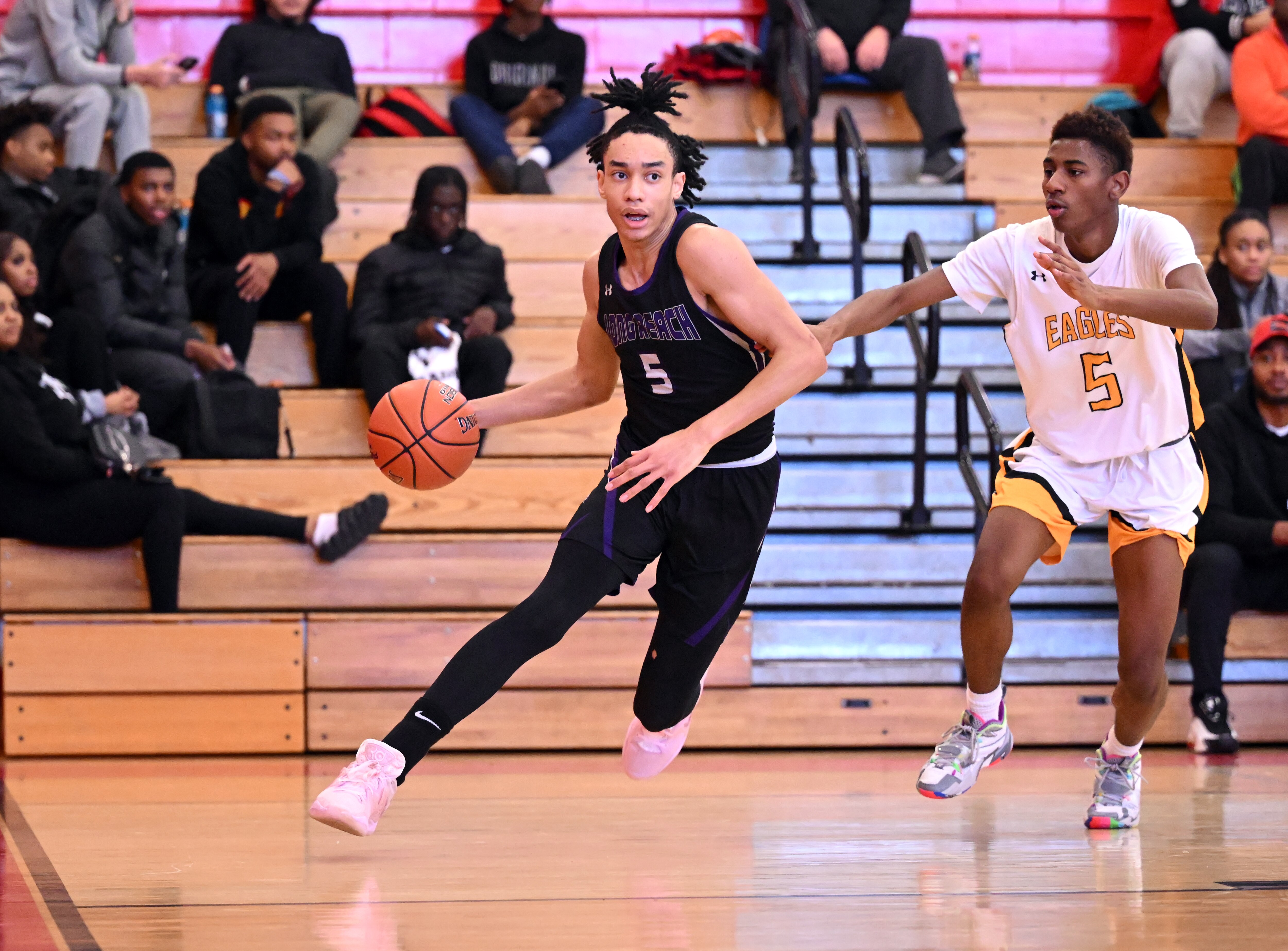 Long Reach's RJ Barnes drives past Northeast's Dion White during Wednesday's boys basketball match at the Bogle Invitational at Glen Burnie. Barnes finished with 16 points as the 13th-ranked Lightning remained undefeated with a 75-59 decision over the previously undefeated Eagles.