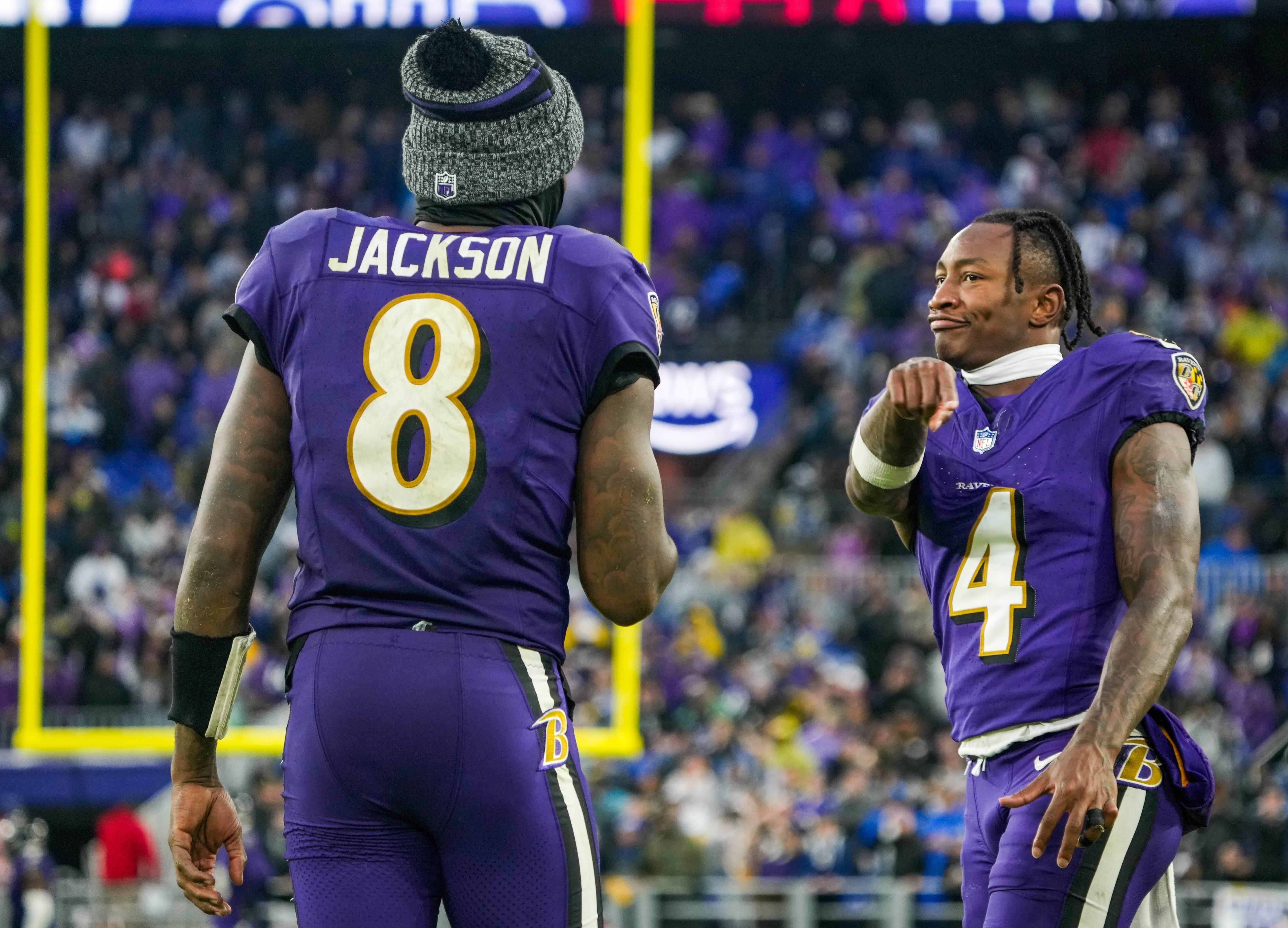 Ravens quarterback Lamar Jackson and wide receiver Zay Flowers come together on the sideline after working together on a go-ahead touchdown in the fourth quarter Sunday against the Rams.