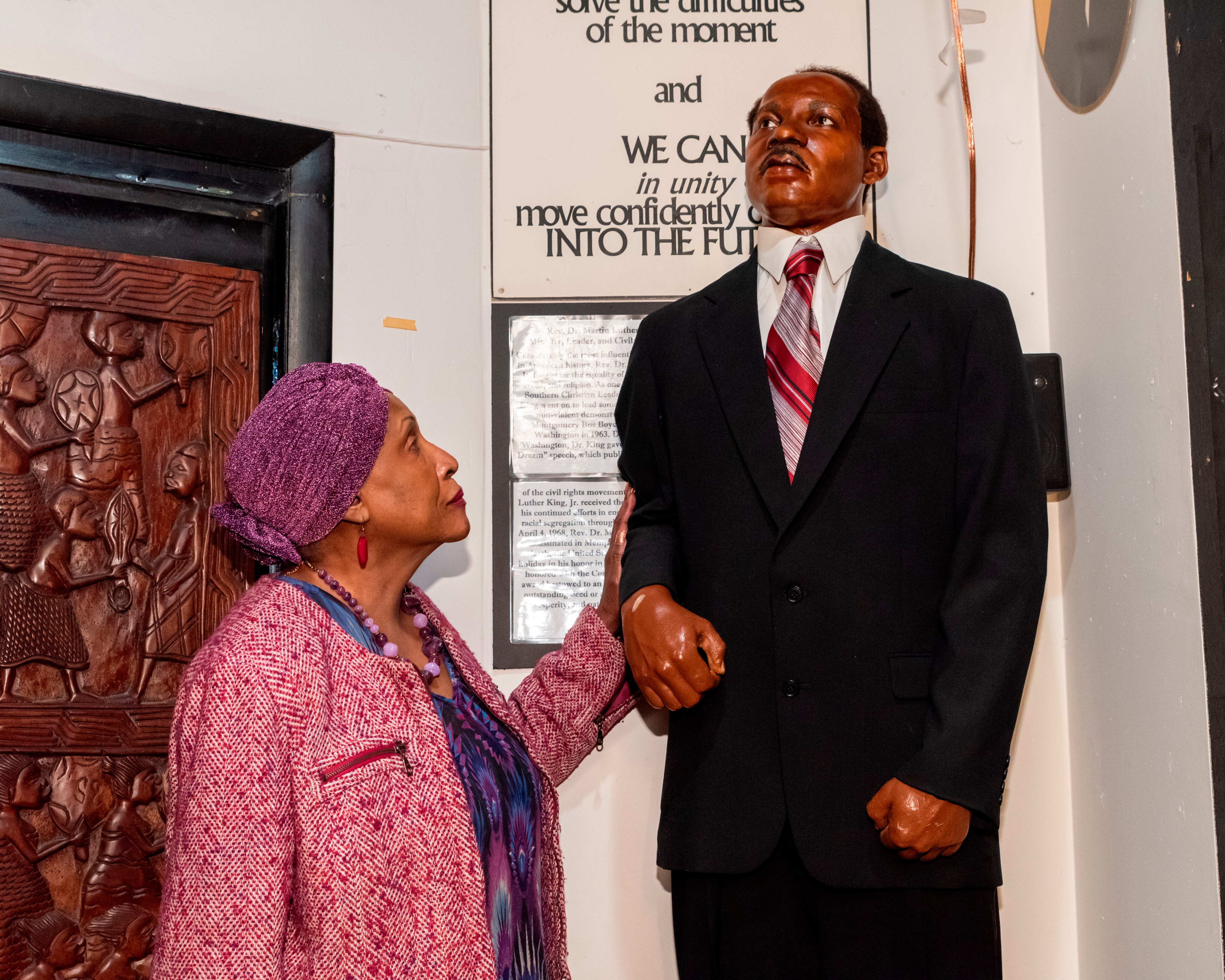 Dr. Joanne Martin, co-founder and executive director of The National Great Blacks in Wax Museum, stands next to a figure representing Dr. Martin Luther King Jr. at the useum in Baltimore.