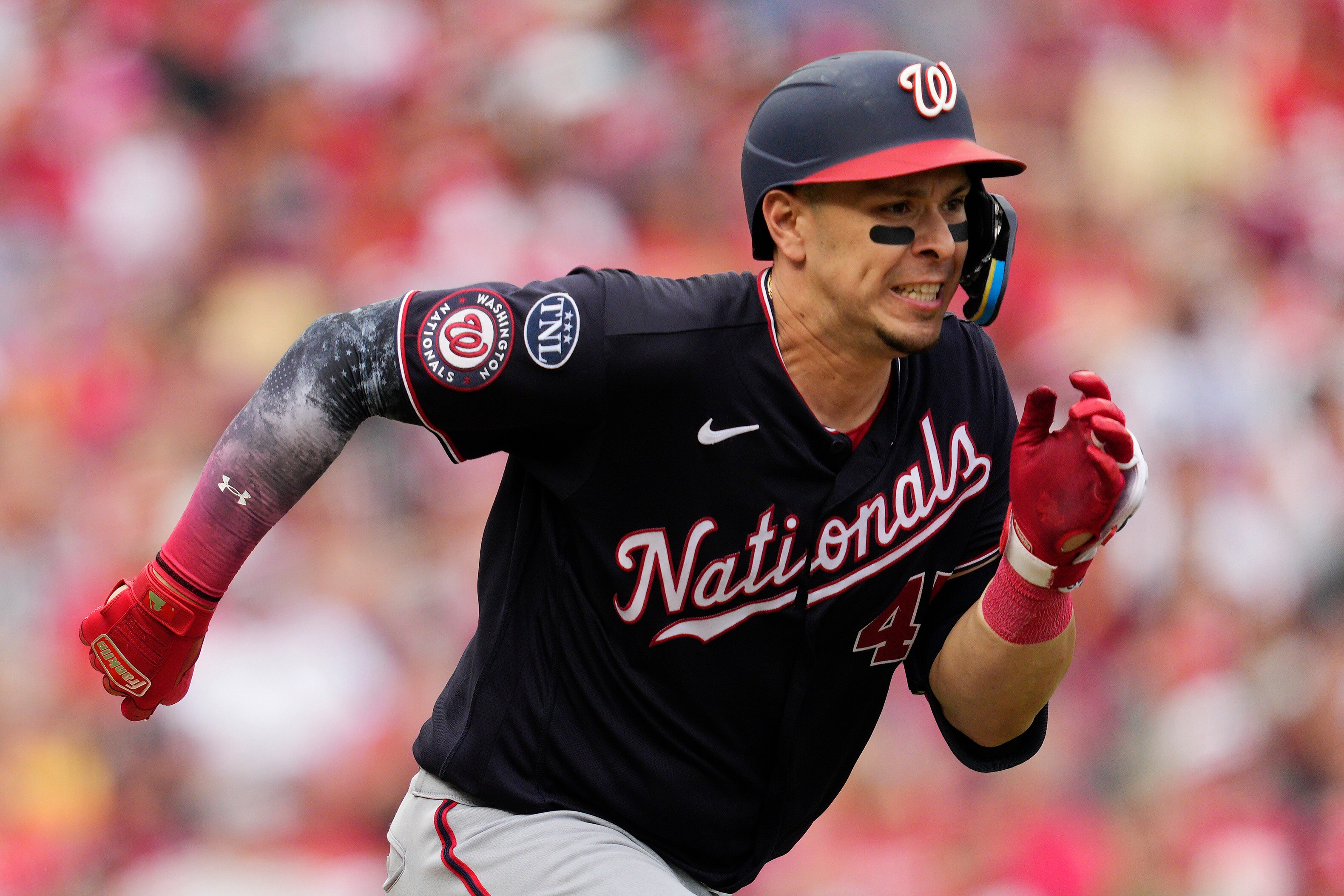 Joey Meneses of the Nationals reaches first base on a fielder's choice and throwing error in the eighth inning of Washington's 7-3 win Saturday.