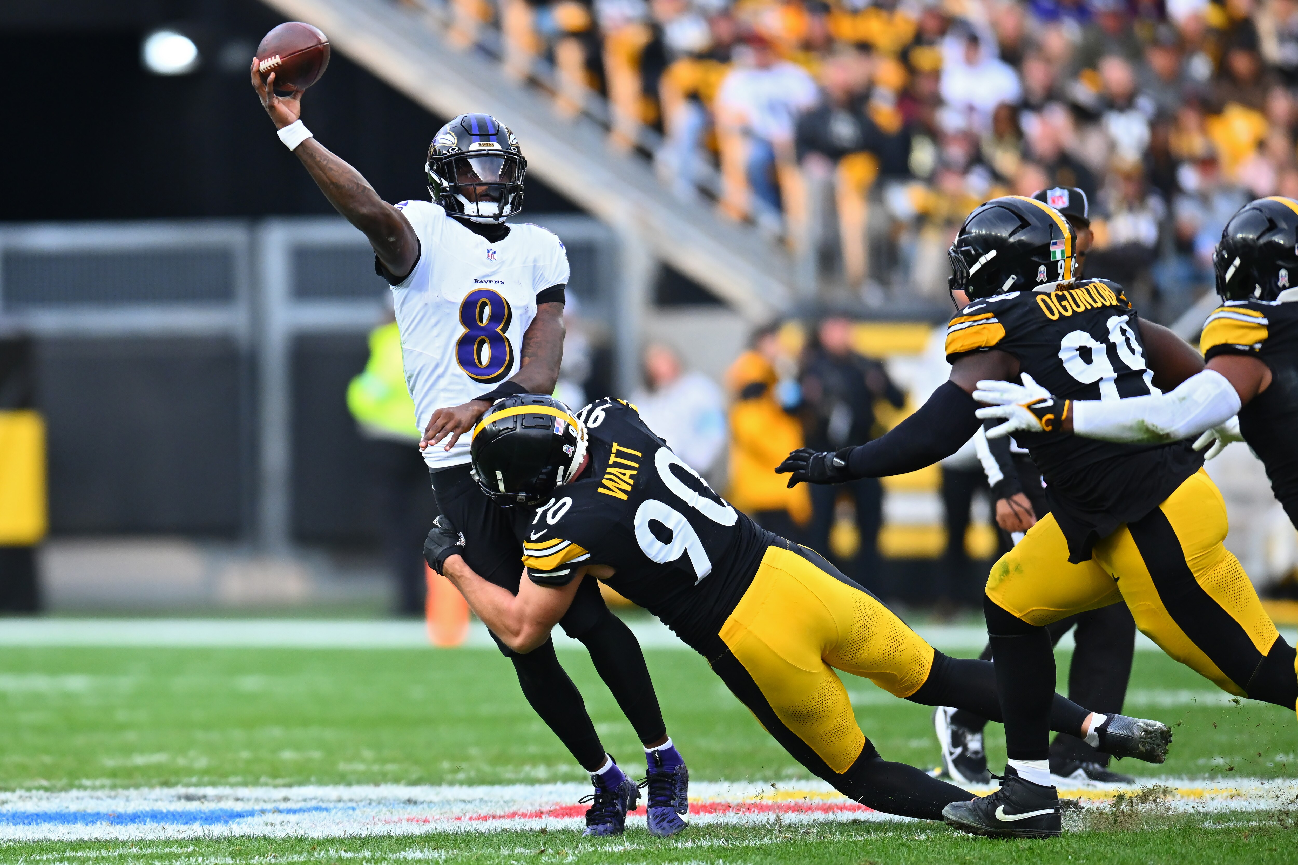 Ravens quarterback Lamar Jackson is hit by T.J. Watt of the Steelers on Sunday during Pittsburgh’s 18-16 victory.