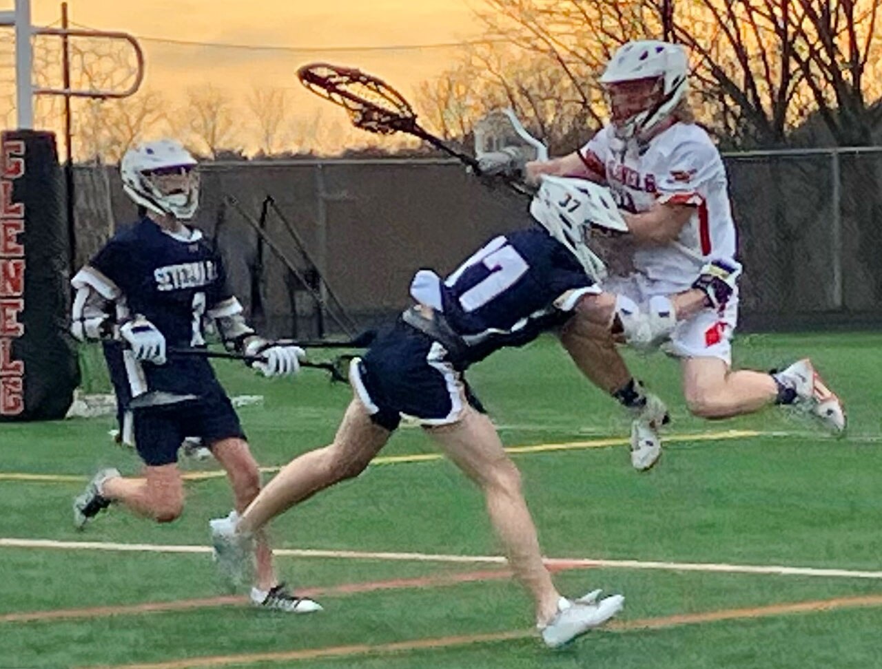 Severna Park junior attackman Kenny Brazil shows what riding is all about as he checks Glenelg sophomore goalie Zach Coughlin while Falcon sophomore midfielder Jack Fish arrives on the scene. No. 9 Severna Park won the inter-county battle, 11-3, over the Gladiators.