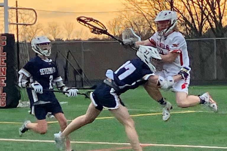 Severna Park junior attackman Kenny Brazil shows what riding is all about as he checks Glenelg sophomore goalie Zach Coughlin while Falcon sophomore midfielder Jack Fish arrives on the scene. No. 9 Severna Park won the inter-county battle, 11-3, over the Gladiators.