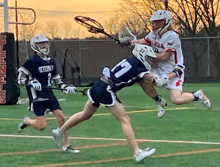 Severna Park junior attackman Kenny Brazil shows what riding is all about as he checks Glenelg sophomore goalie Zach Coughlin while Falcon sophomore midfielder Jack Fish arrives on the scene. No. 9 Severna Park won the inter-county battle, 11-3, over the Gladiators.