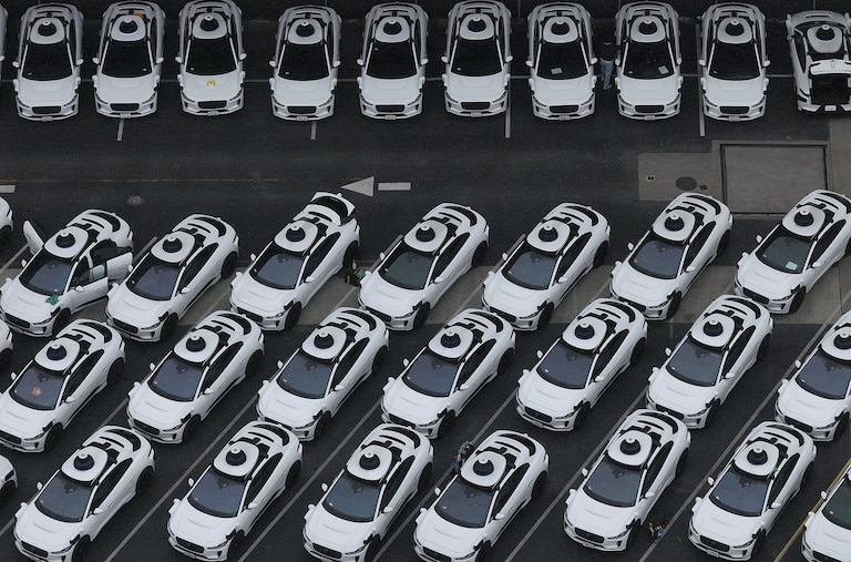 SAN FRANCISCO, CALIFORNIA - JUNE 10: In an aerial view, Waymo cars are seen parked at a Waymo facility on June 10, 2025 in San Francisco, California. Robo-taxi company Waymo has limited service in San Francisco after several Waymo cars were set on fire and destroyed during the anti-immigration protests in Los Angeles over the past week.