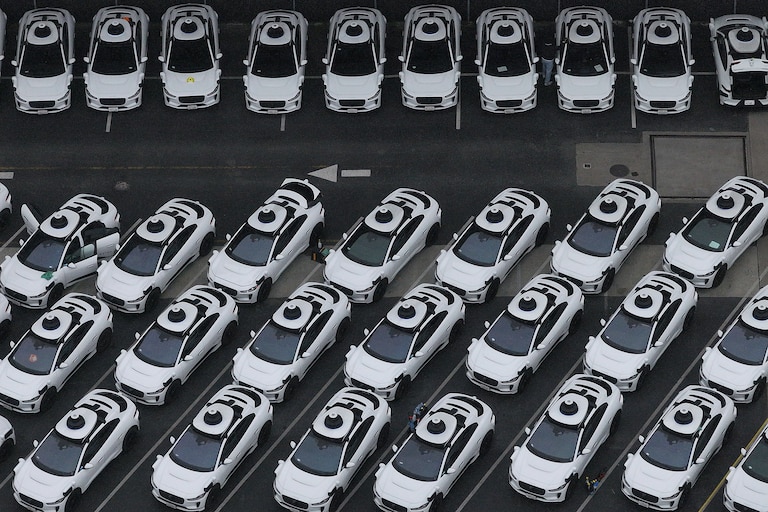 SAN FRANCISCO, CALIFORNIA - JUNE 10: In an aerial view, Waymo cars are seen parked at a Waymo facility on June 10, 2025 in San Francisco, California. Robo-taxi company Waymo has limited service in San Francisco after several Waymo cars were set on fire and destroyed during the anti-immigration protests in Los Angeles over the past week.