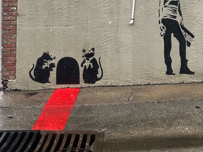 Graffiti in an alley off Fait Avenue near S. Potomac Street in Canton looks like it could be done by the artist Banksy. But both images are recreations of existing pieces.