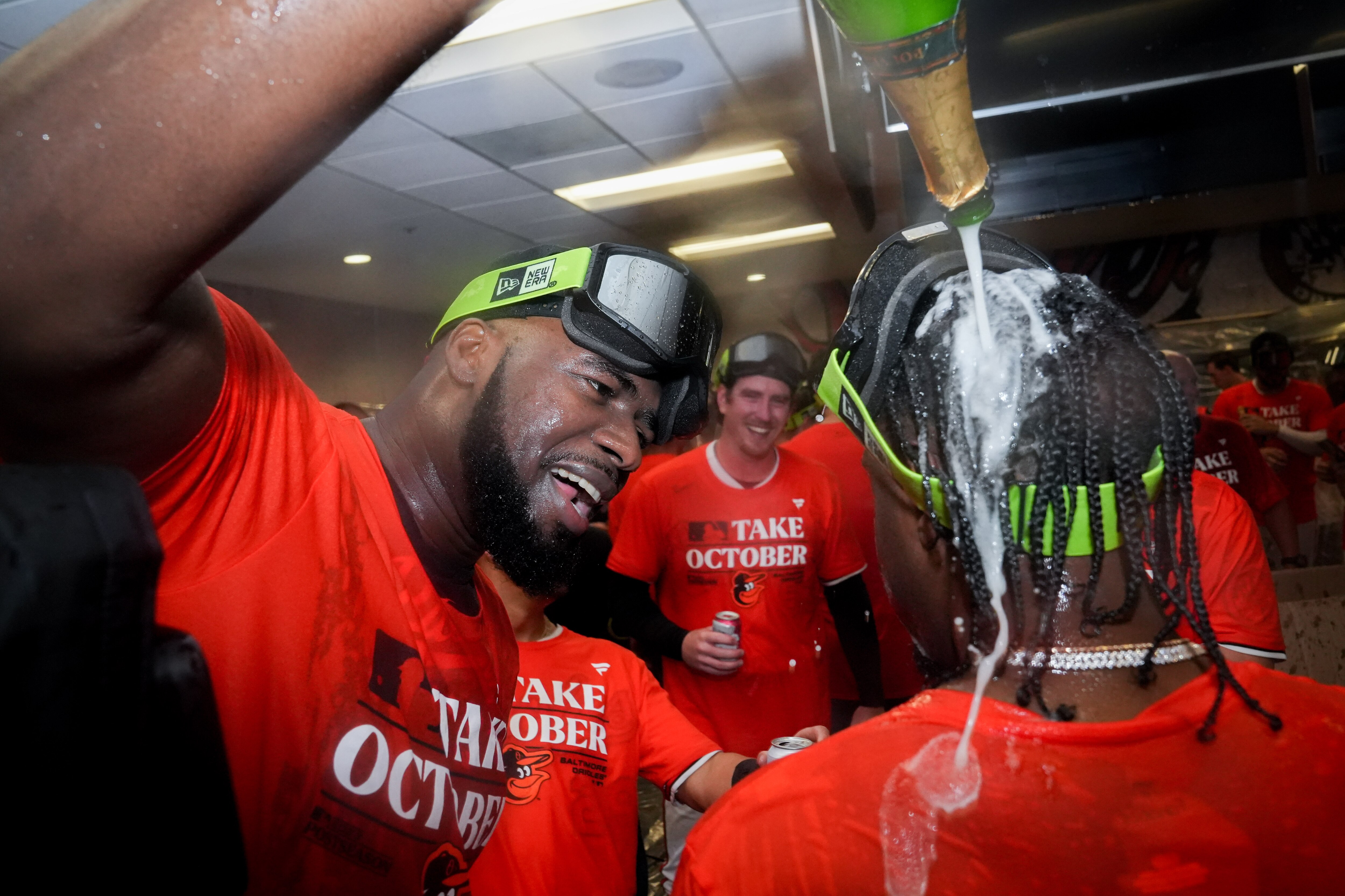 Baltimore Orioles relief pitcher Félix Bautista douses shortstop Jorge Mateo with champagne in the clubhouse following the team’s playoff-clinching win against the Tampa Bay Rays on Sunday, Sept. 17, 2023. The Orioles earned a spot in the playoffs for the first time since 2016.