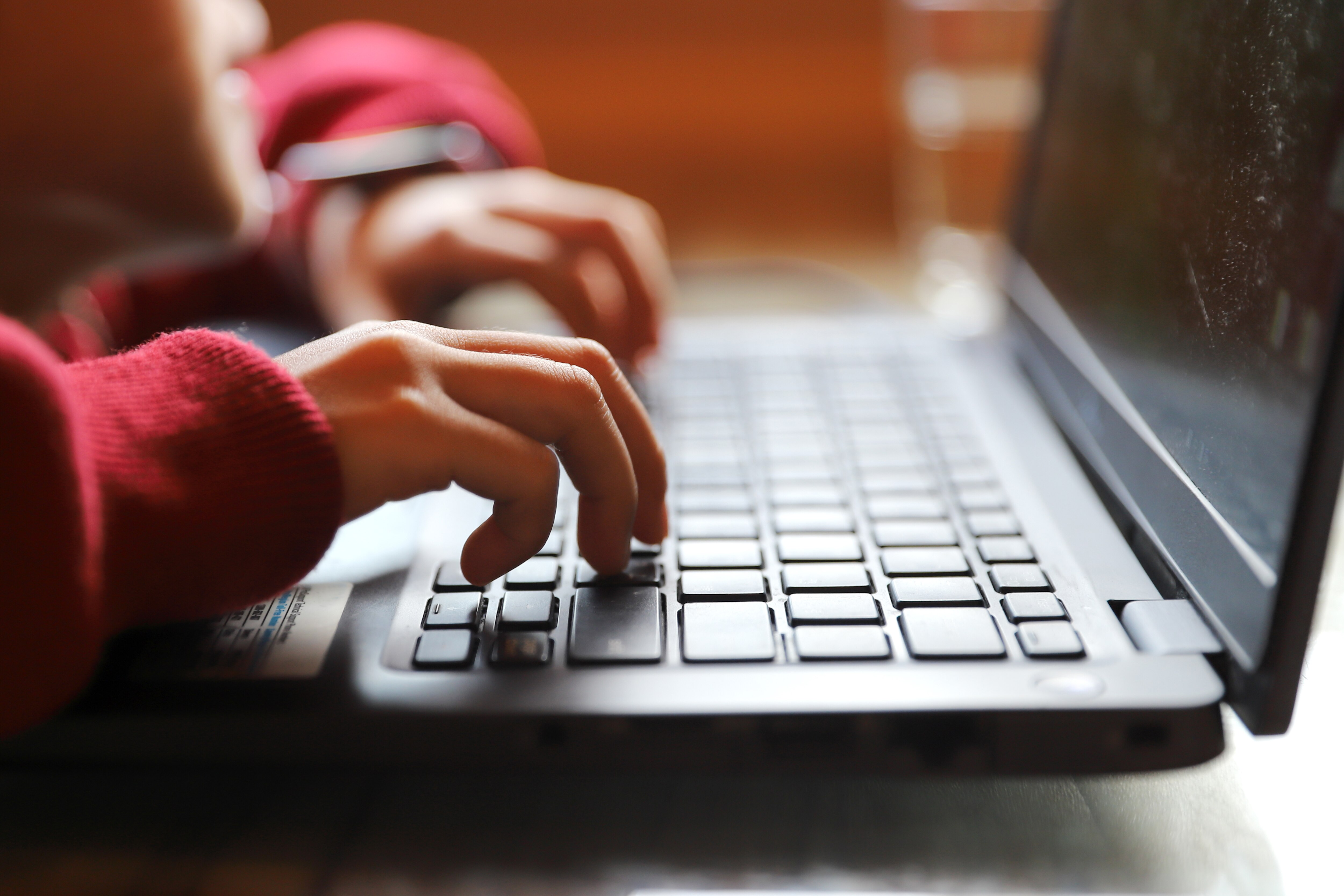 A child uses a laptop.