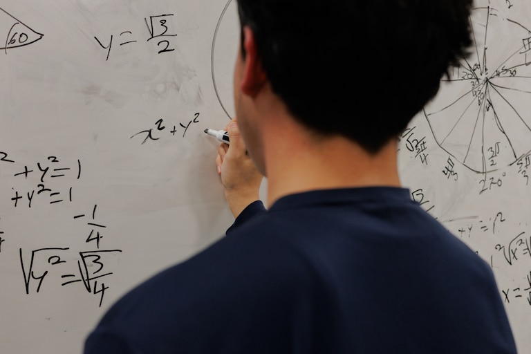 An undocumented student revisits a math problem from class earlier that day at his school in Baltimore, Maryland.