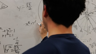 An undocumented student revisits a math problem from class earlier that day at his school in Baltimore, Maryland.