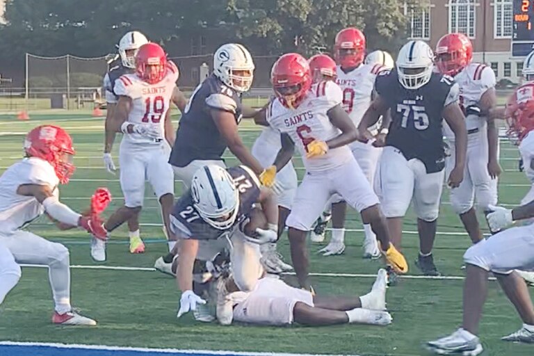 Gilman's Sebastian Chaney lunges across the goal line for the game winning touchdown in overtime, lifting the Greyhounds to a 27-21 victory over Concordia Prep on Aug. 26.