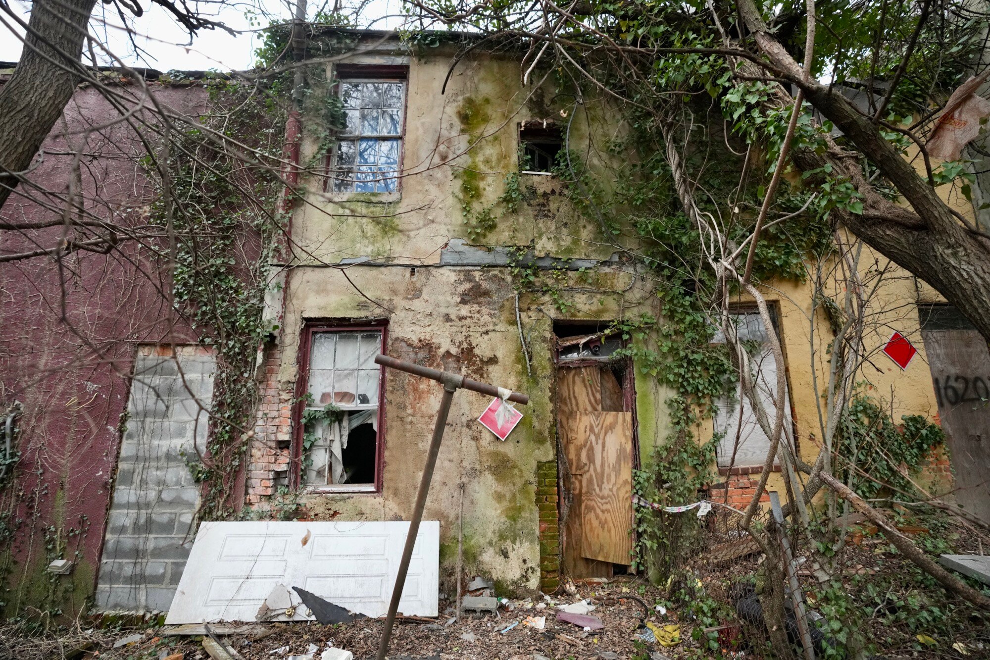 Mayor Brandon Scott speaks outside of vacant homes on West Saratoga street during a press conference hosted by Build One Baltimore on February 16, 2023.