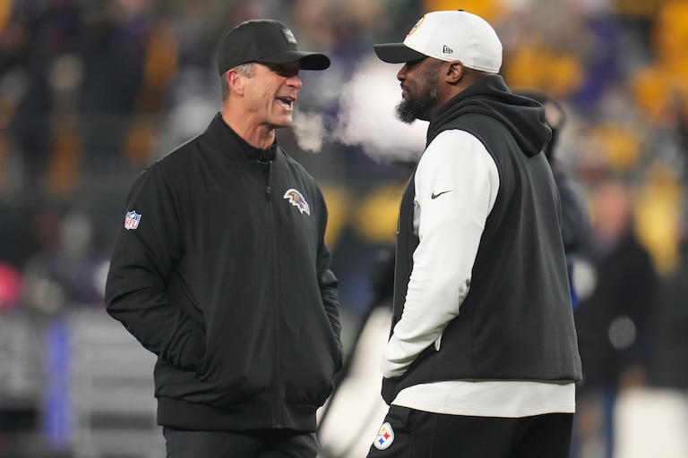 Baltimore Ravens head coach John Harbaugh, left, and Pittsburgh Steelers head coach Mike Tomlin, right, talk before an NFL football game Sunday, Jan. 4, 2026, in Pittsburgh.