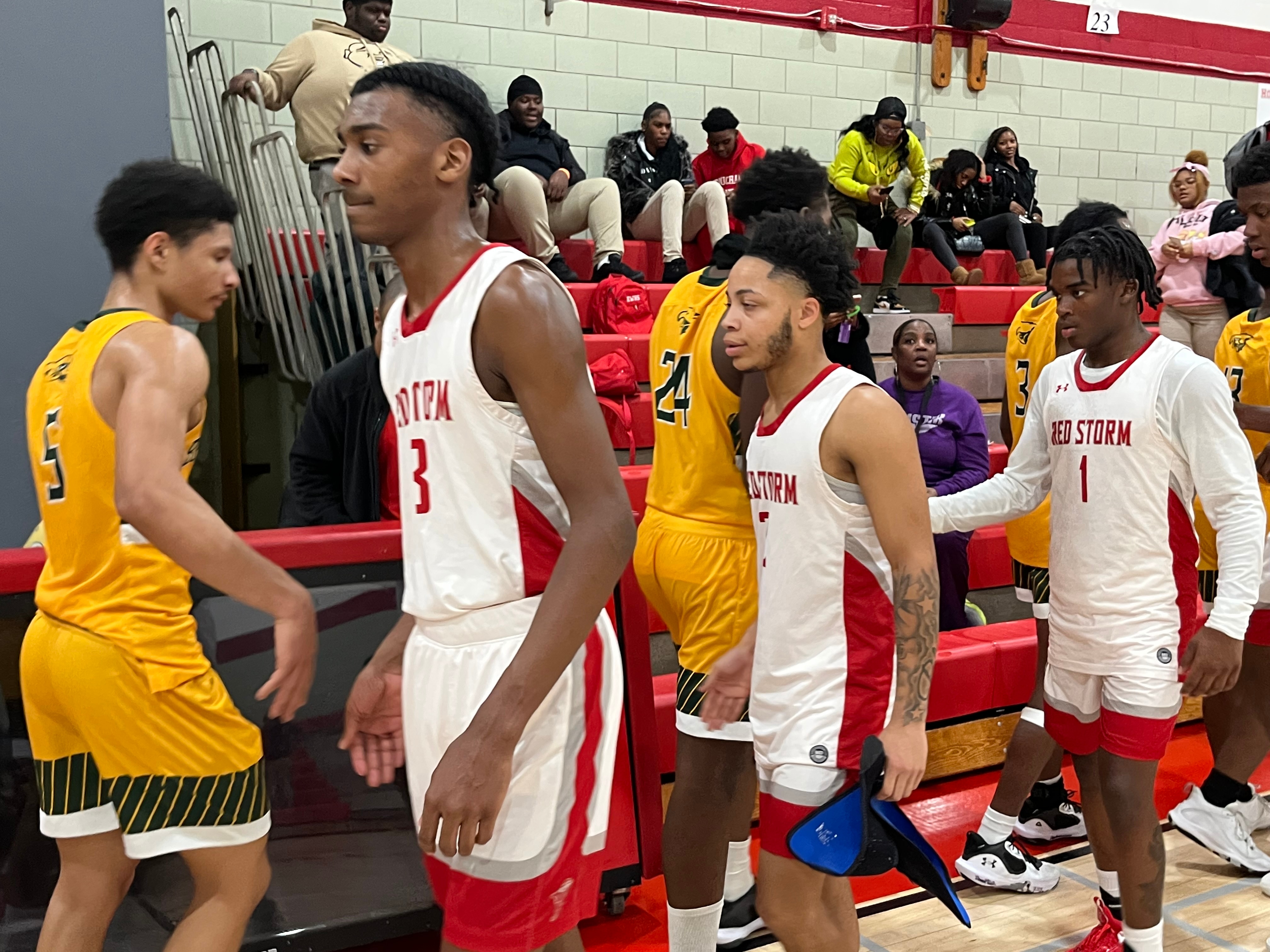 Edmondson's Josiah Brown (left), Christian Smith and DJ Dantzler exchanged handshakes with Benjamin Franklin following Tuesday's Baltimore City boys basketball contest. The No. 8 Red Storm won, 76-51, in their first home match with spectators after none were allowed for last week after a student was fatally shot and four other students  wounded at the nearby Edmondson Village Shopping Center in West Baltimore.