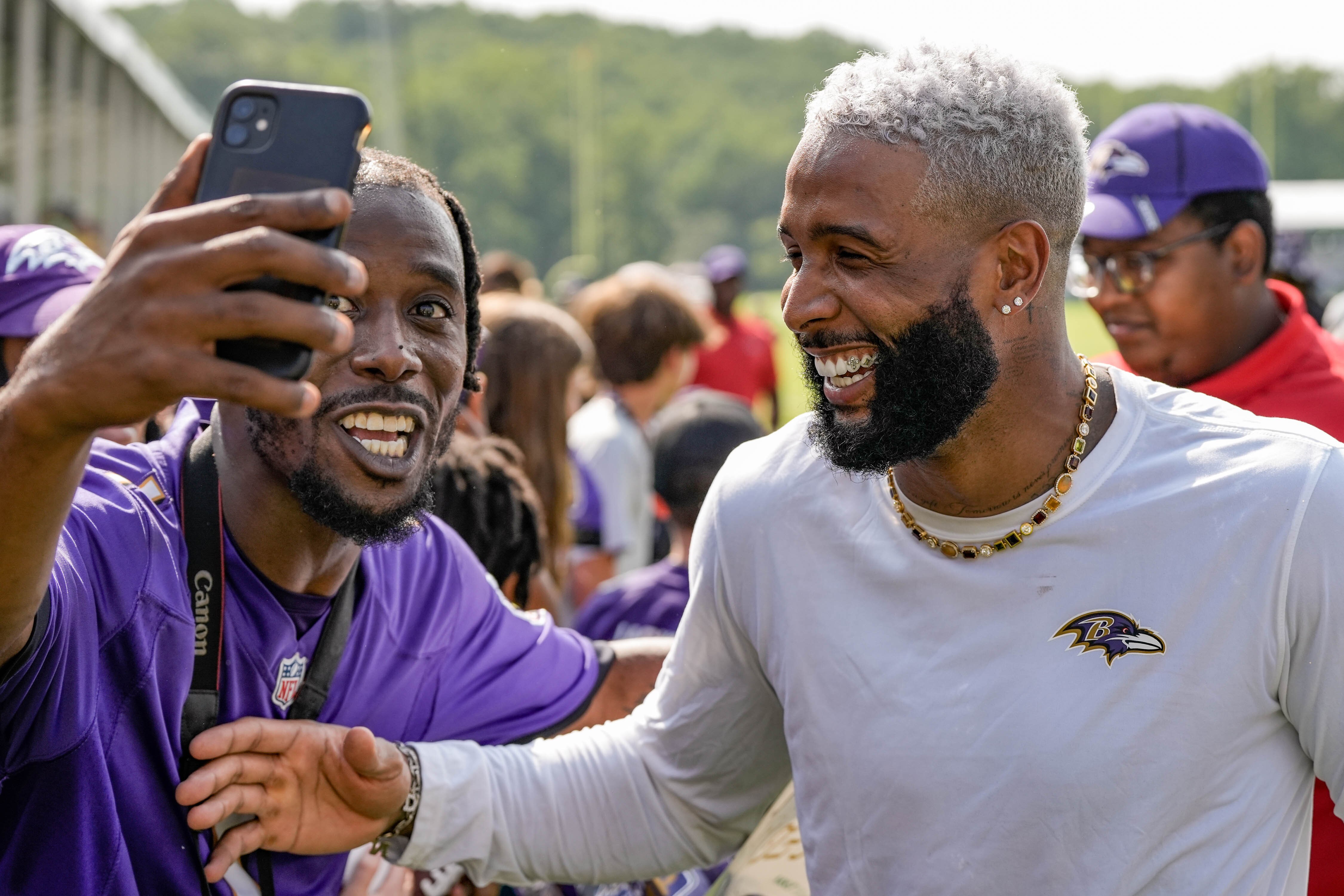 Ravens WR Odell Beckham Jr. laughs with a fan at the first Ravens practice of the season in Owings Mills on July 26, 2023.