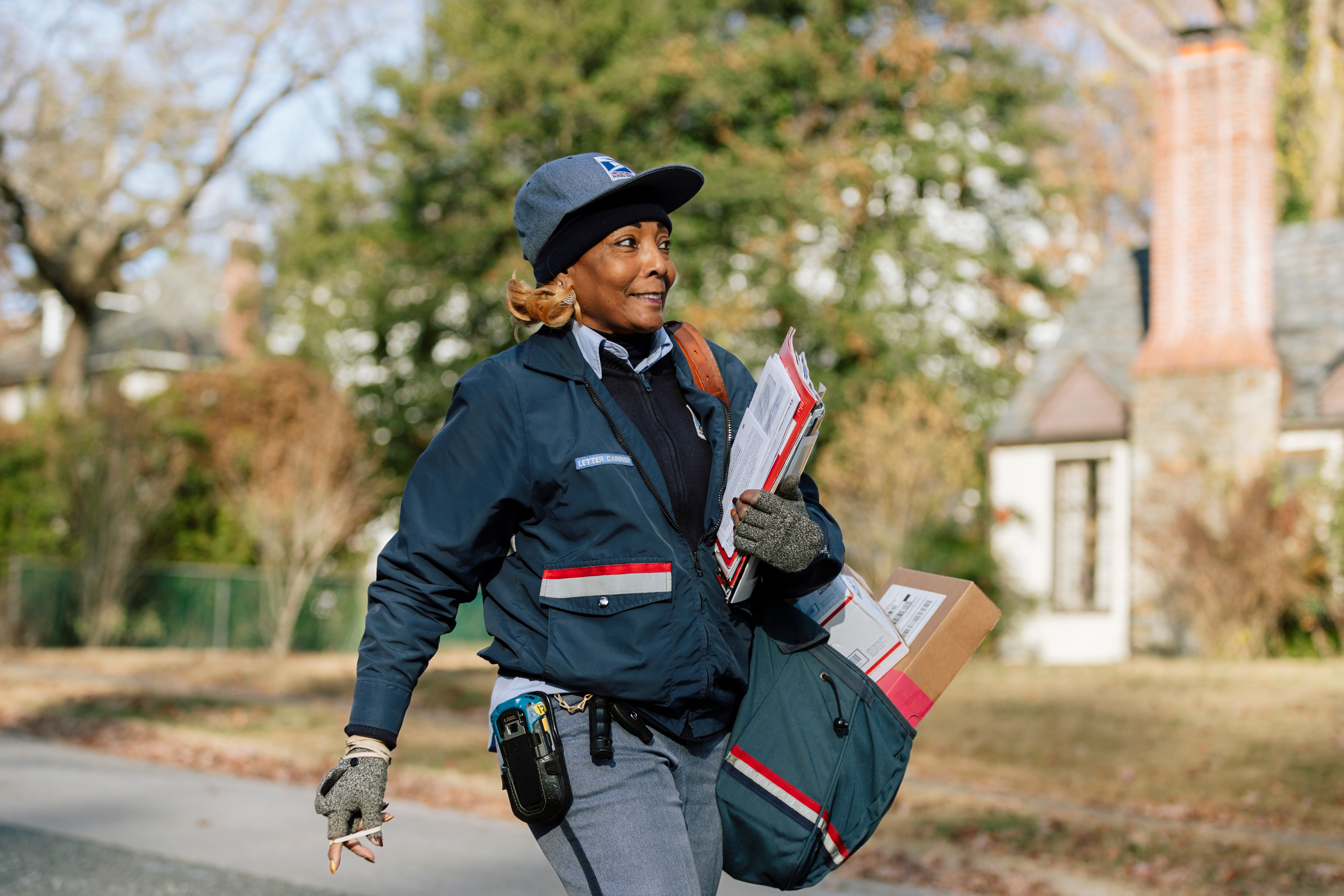 JoAnn Dowery walks the final mail route of her 32-year career, around the Ten Hills neighborhood on Saturday, Nov. 30, 2024 in Baltimore, MD.