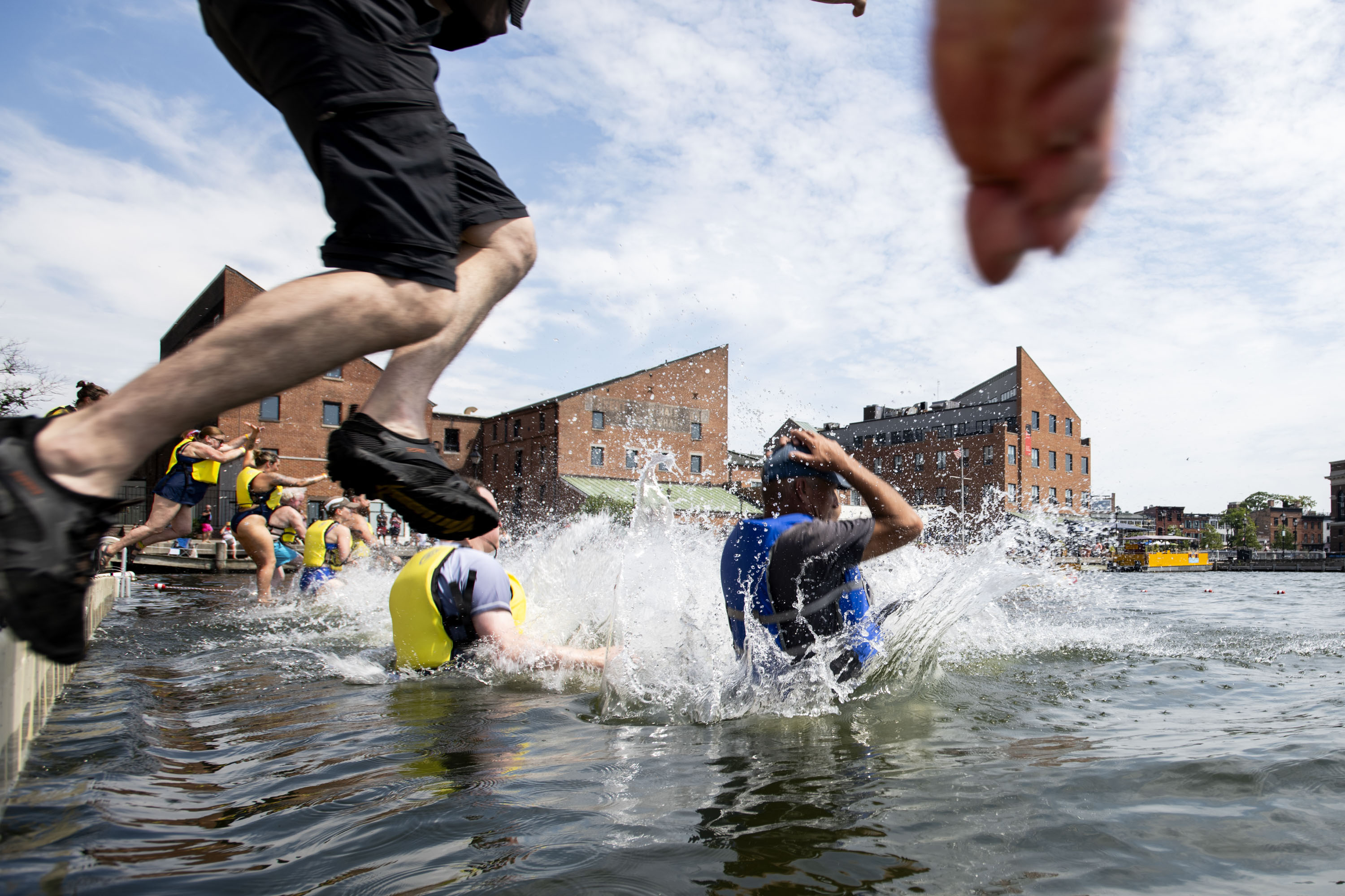 Harbor jumpers leap into the waters of Fells Point during the Harbor Splash 2024 event on 6/23/24 in Baltimore, MD.