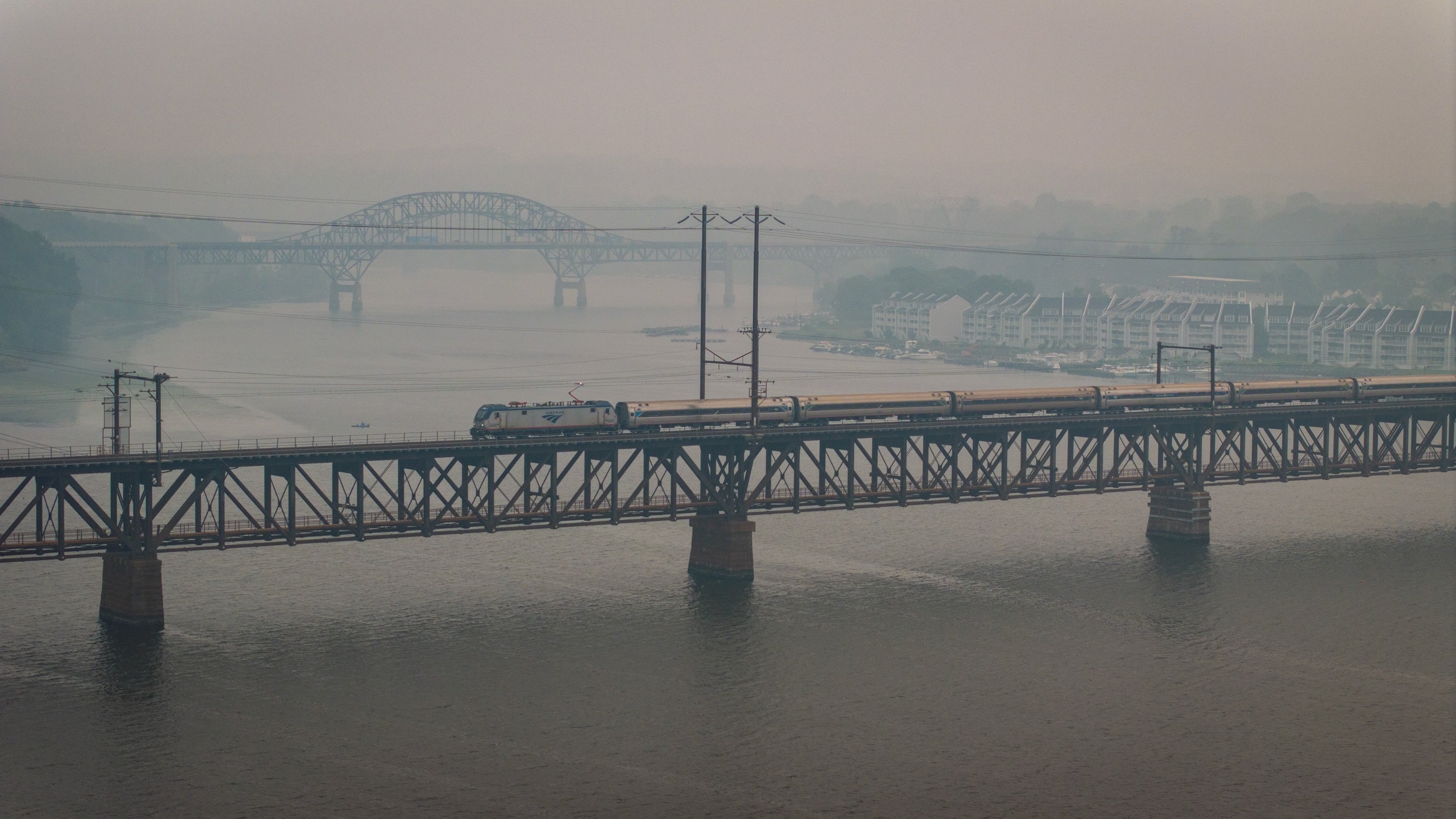 A southbound Amtrak crosses the Susquehanna River at Havre de Grace in the haze of wildfire smoke from Canada on Friday.