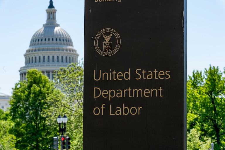 FILE - In this May 7, 2020, file photo, the entrance to the Labor Department is seen near the Capitol in Washington. (AP Photo/J. Scott Applewhite, File)