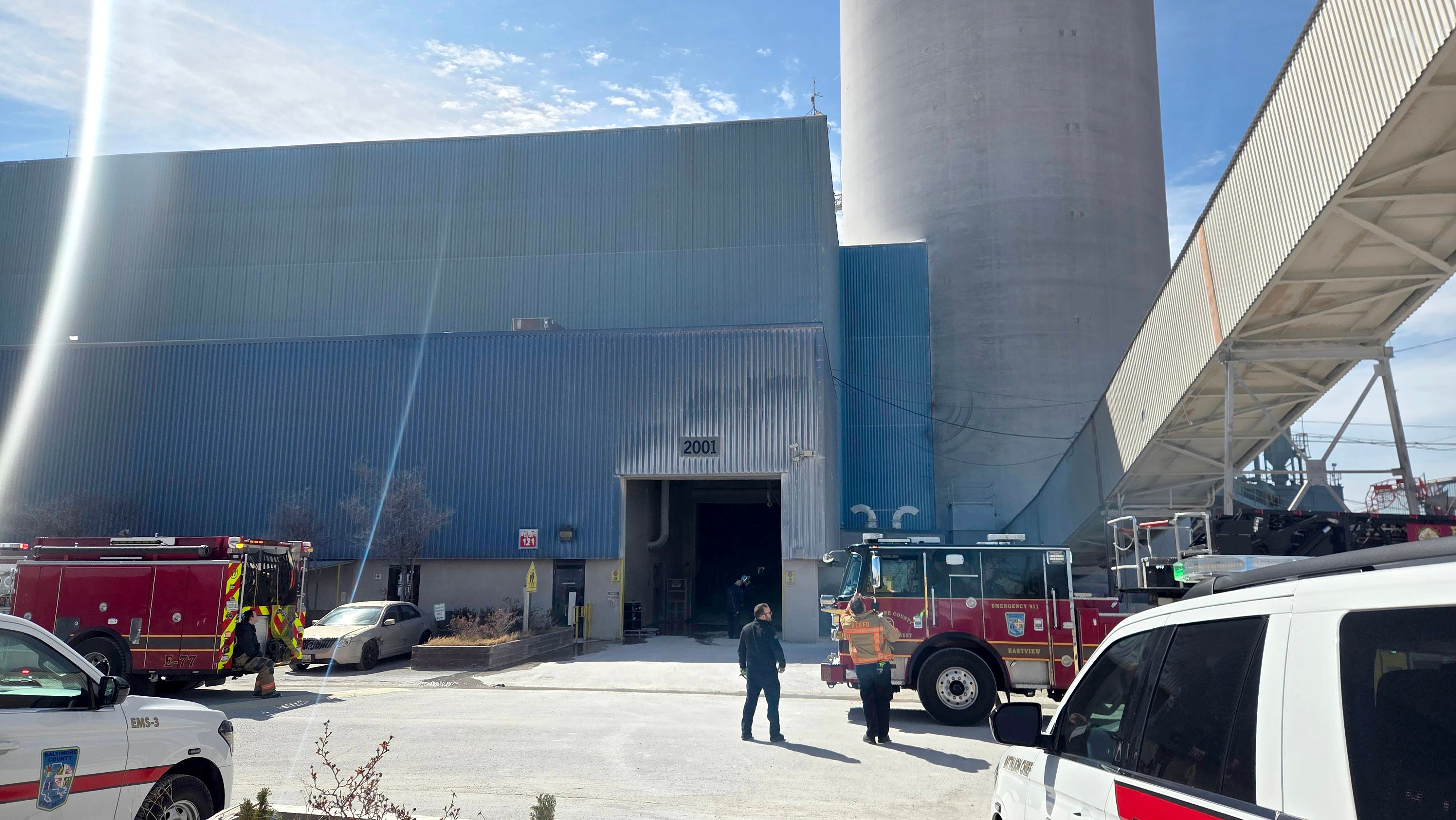Baltimore County Fire and emergency personnel work to rescue two concrete plant workers stuck in an elevator near the 1100 block of Wharf Road in Sparrows Point.