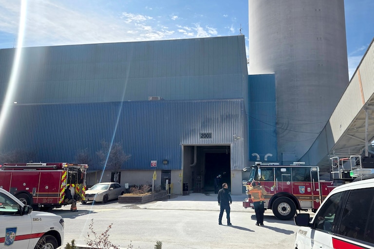 Baltimore County Fire and emergency personnel work to rescue two concrete plant workers stuck in an elevator near the 1100 block of Wharf Road in Sparrows Point.