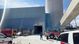Baltimore County Fire and emergency personnel work to rescue two concrete plant workers stuck in an elevator near the 1100 block of Wharf Road in Sparrows Point.